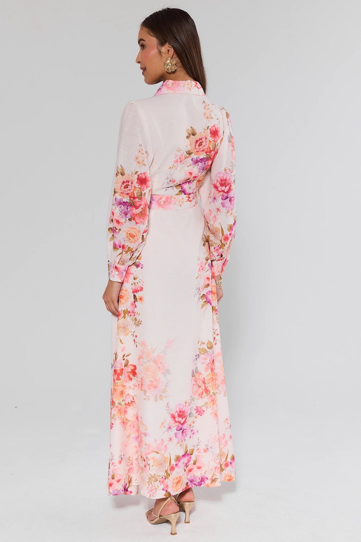 Woman wearing a floral dress with a plain background