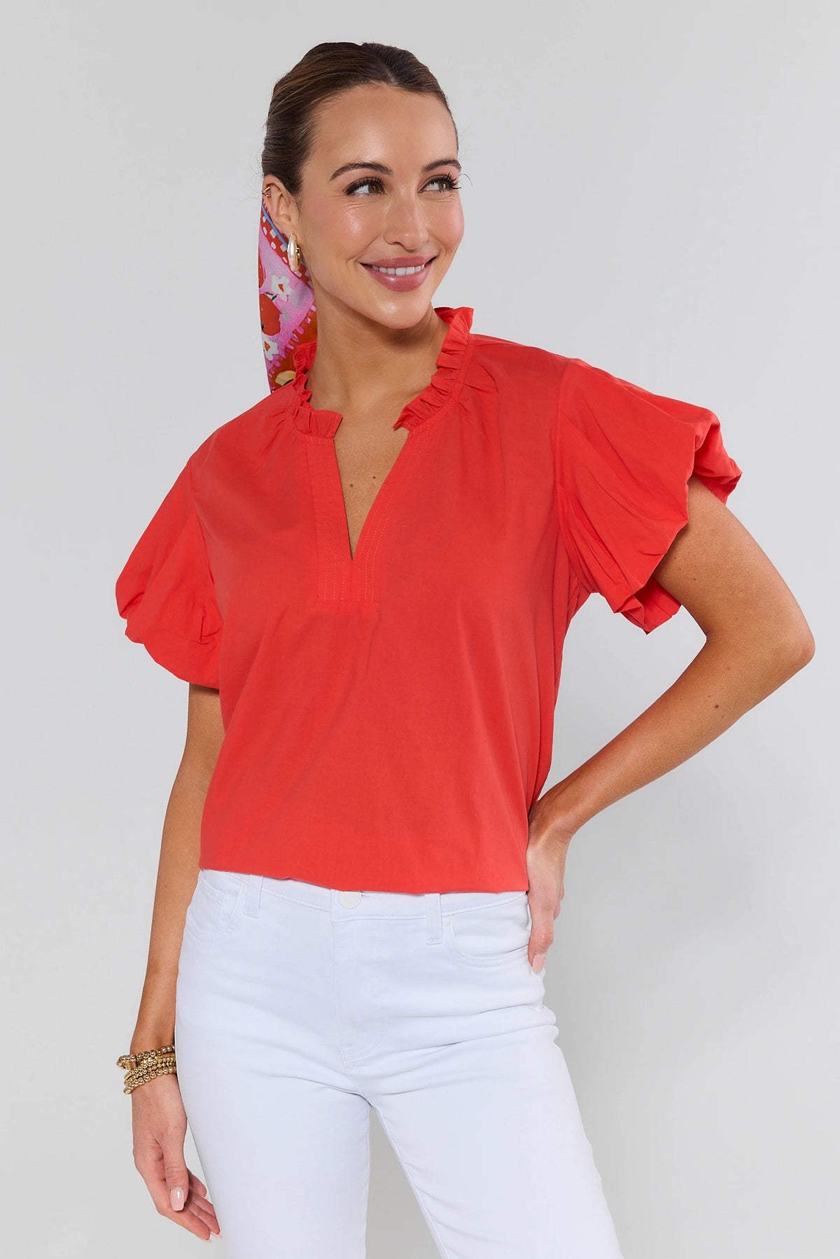 Orange Agnes Split Neck Top with ruffle sleeves and collar, styled with white pants - Front View | Avara