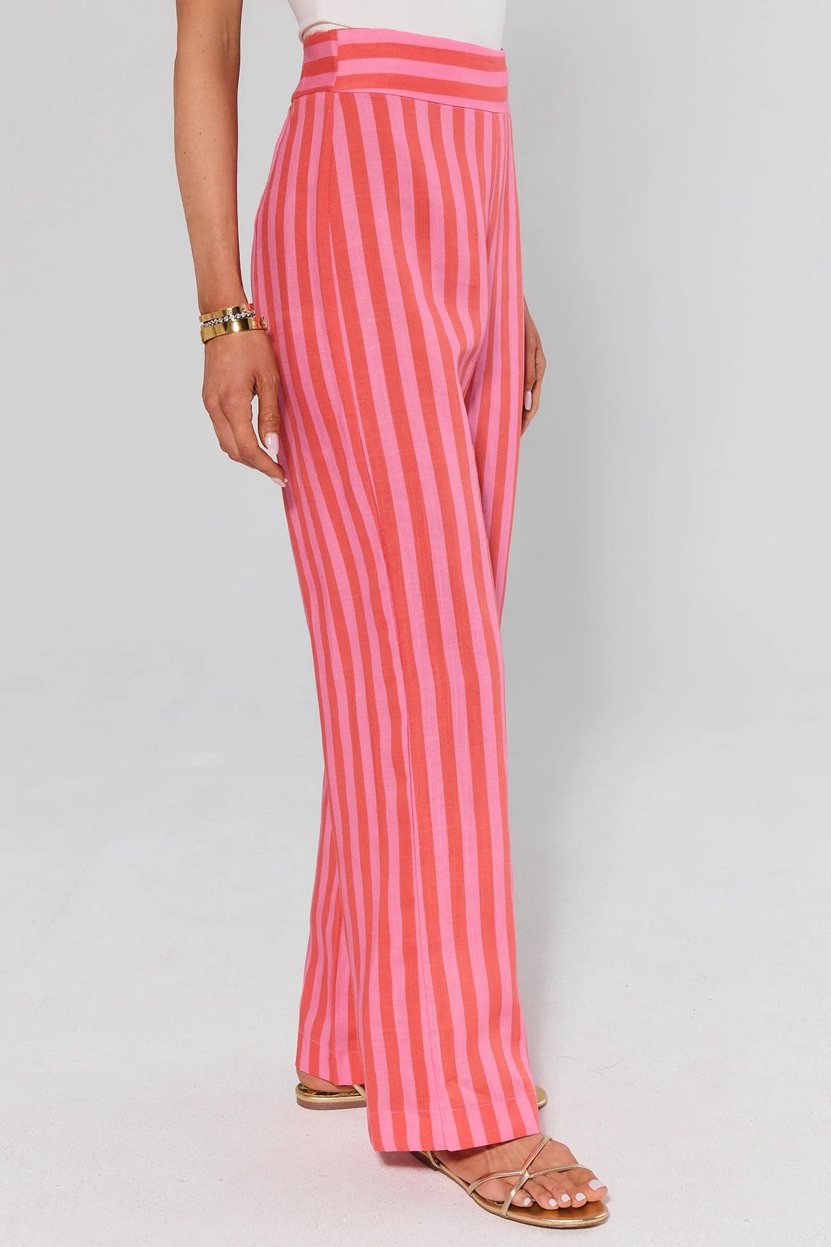 Delilah Pink Striped Flare Pants high-rise waistband detail - Side Profile On Model | Avara