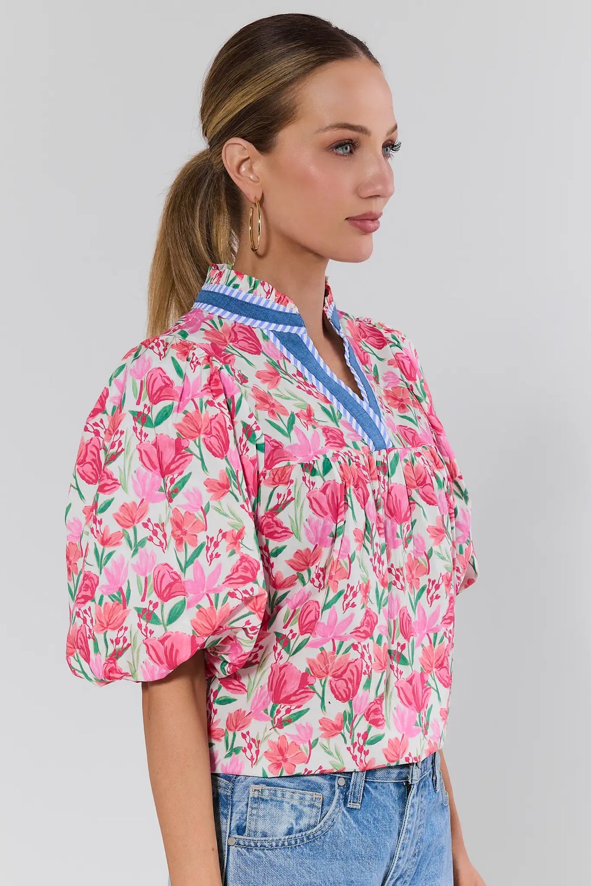 Pink Floral Puff Sleeve Top with Blue Trim - Side View On Model with Jeans | Avara