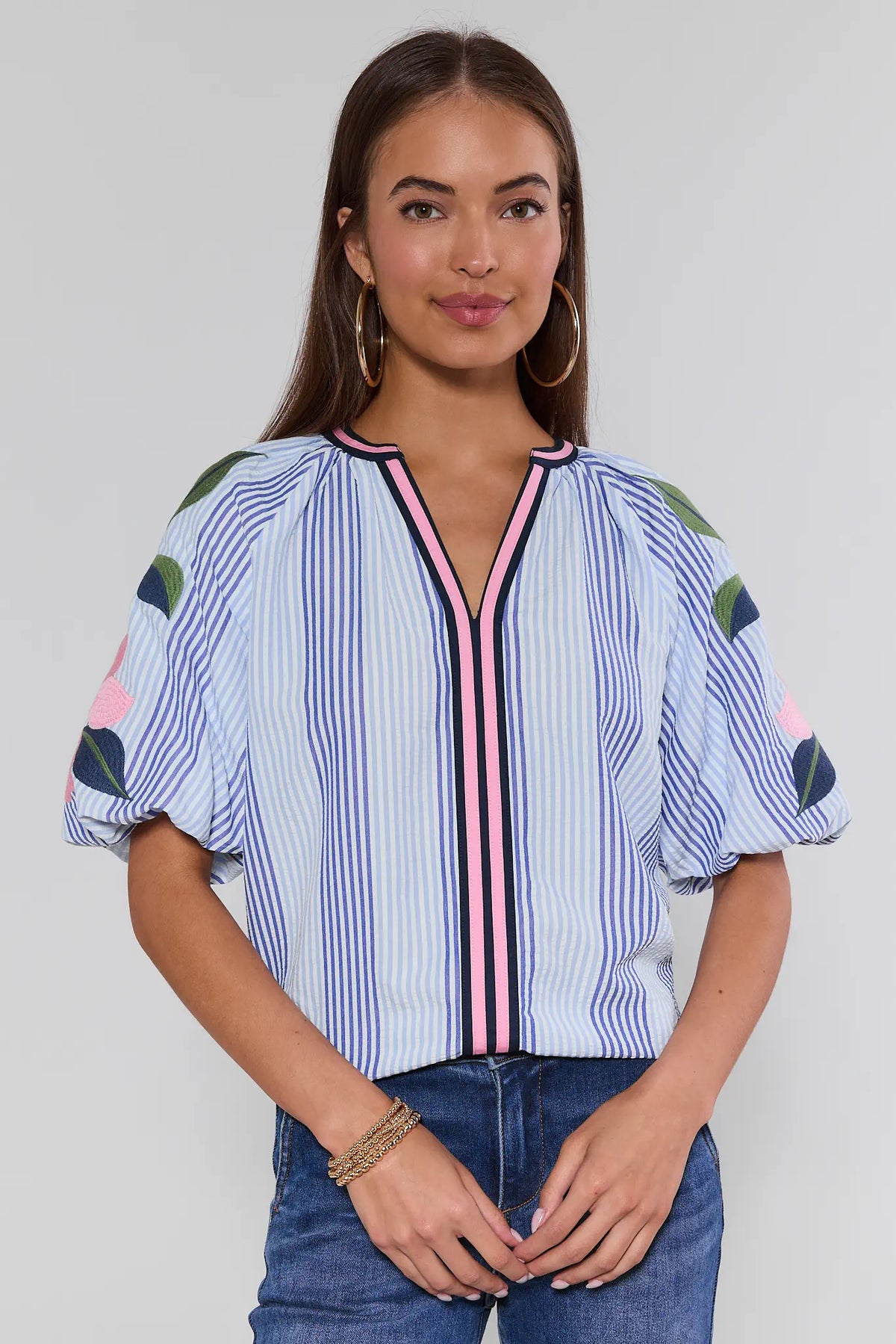Blue striped puff sleeve top with floral embroidered sleeves and pink trim - Front View | Avara