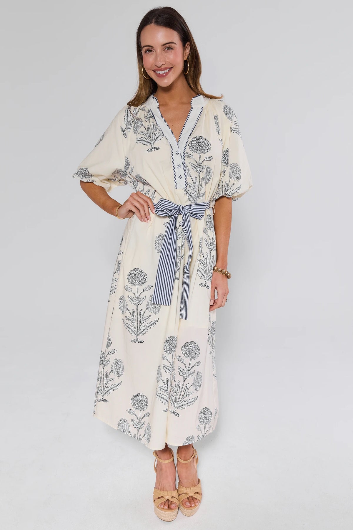 Woman wearing a floral dress with a white background