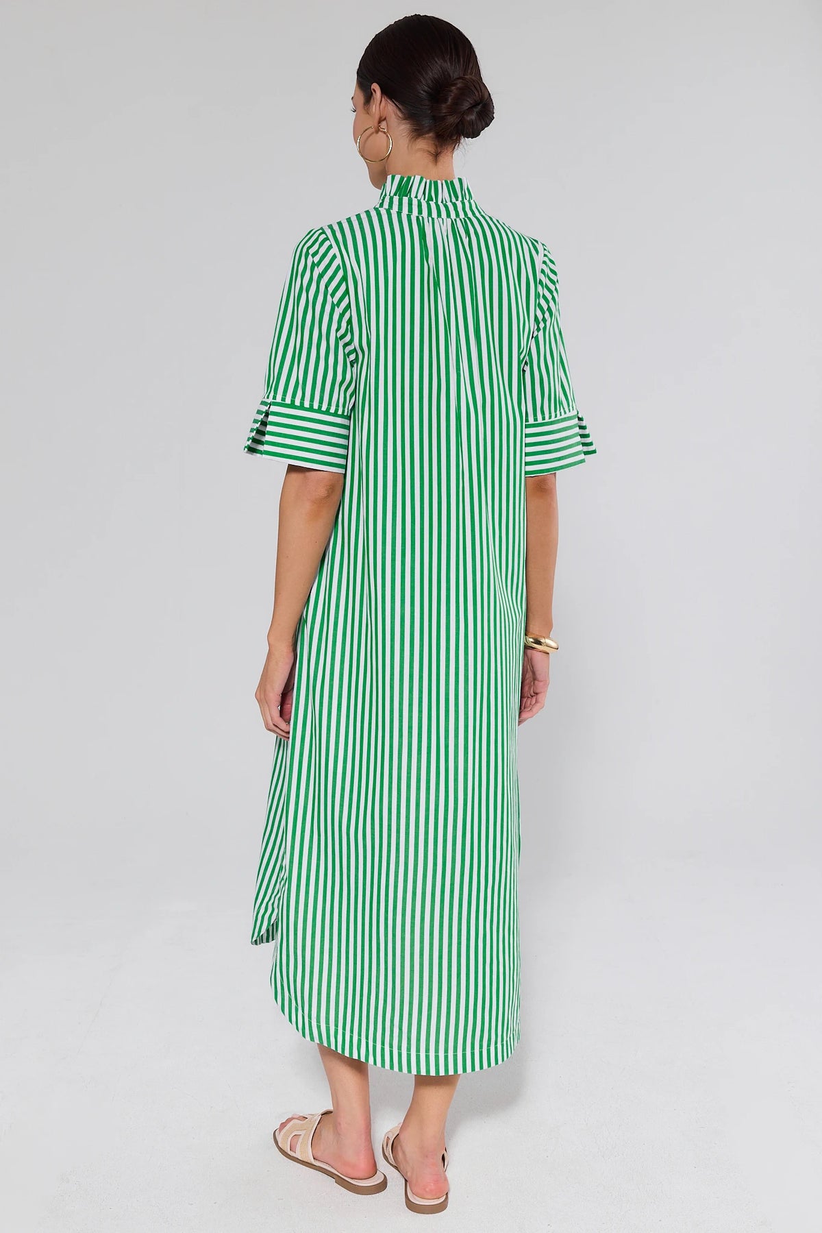 Back view of green and white striped midi dress with cuffed sleeves and slide sandals | Avara