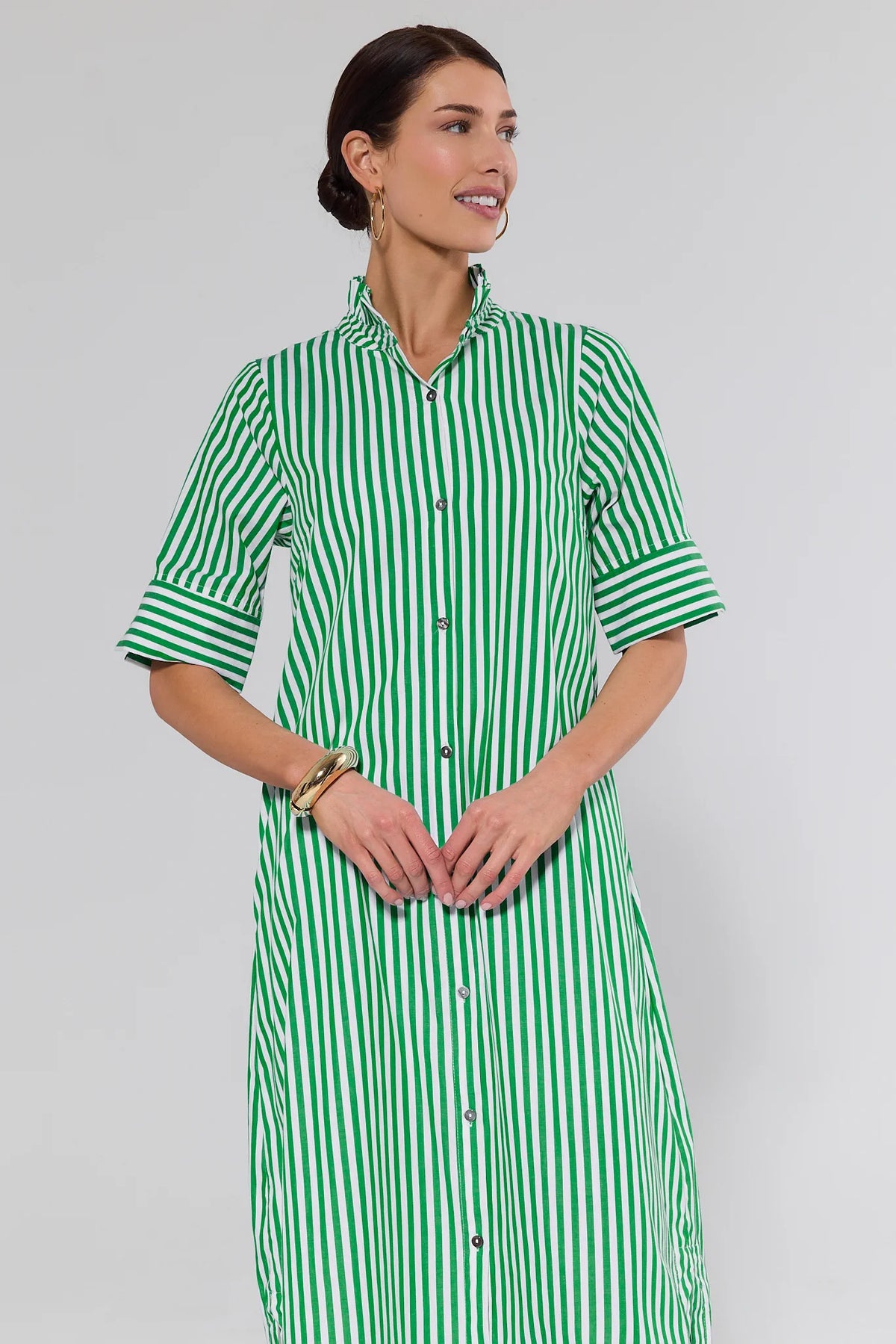 Woman wearing green and white striped midi dress with ruffle collar, front crop view | Avara