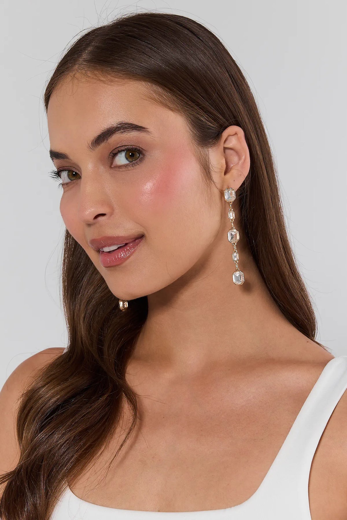 Woman wearing Diana Gold Rhinestone Drop Earrings - On Model Side Profile | Avara
