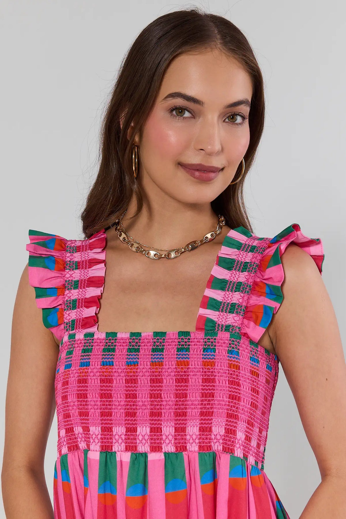 Woman wearing Amelia Gold Layered Chain Necklace styled with colorful smocked dress - On Model | Avara