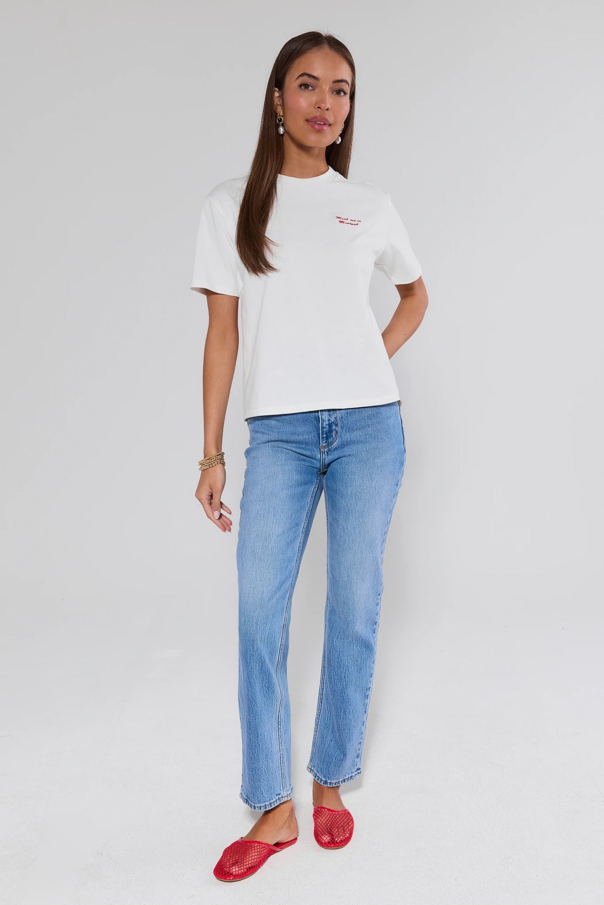 Montauk White Embroidered Tee styled with light wash jeans and red slides - Full Length View | Avara