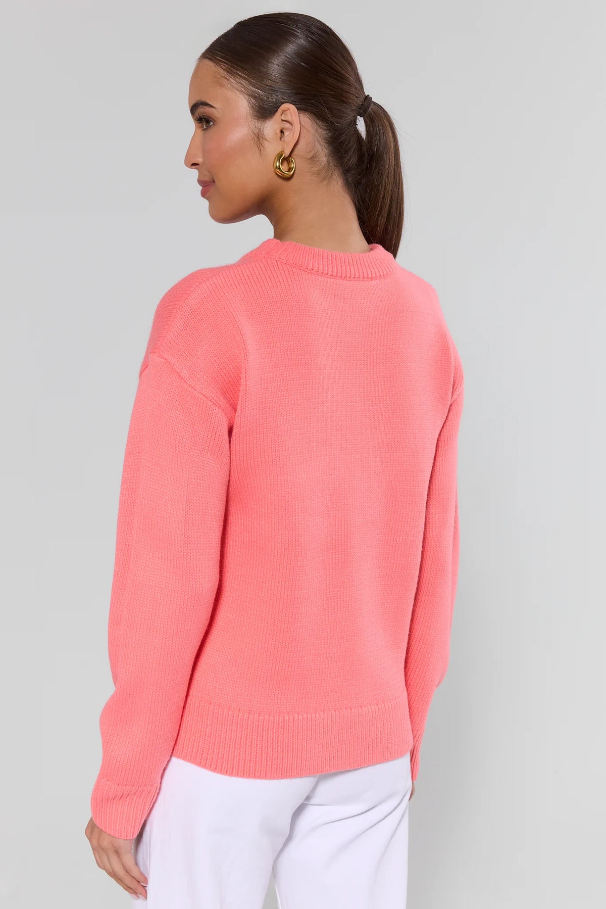 Montauk coral knit sweater back view showing clean ribbed hem and lightweight knit texture | Avara