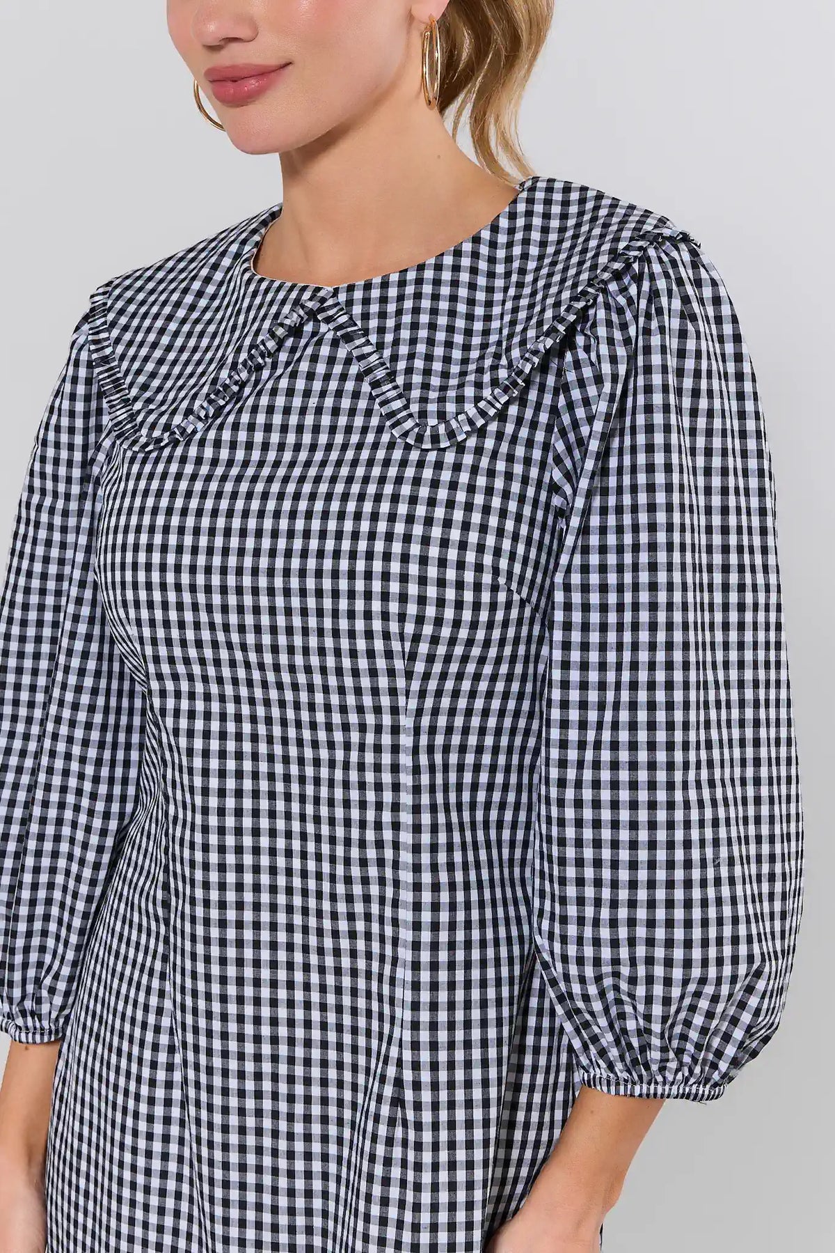 Black gingham short dress ruffle collar and puff sleeve close-up detail - Front Detail | Avara