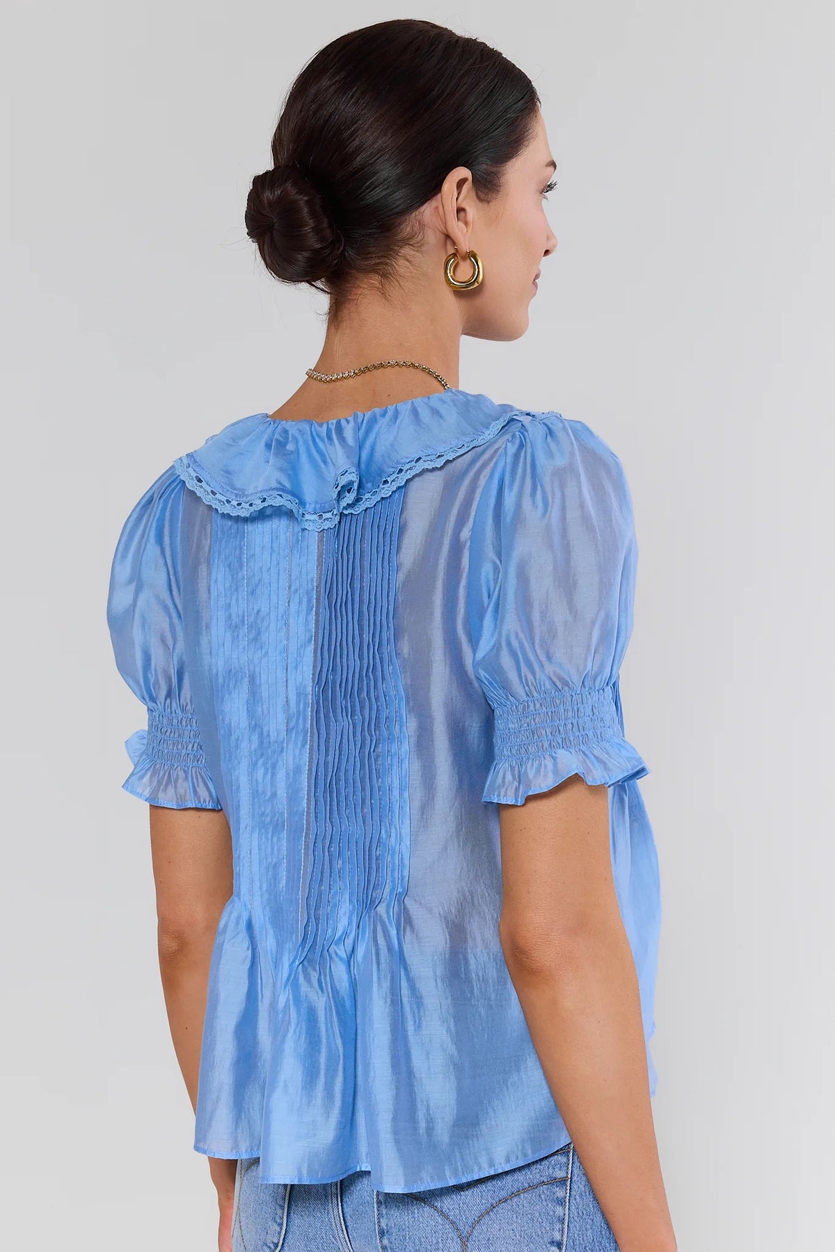 Blue ruffle blouse with puff sleeves and ruffled neckline - Back View | Avara