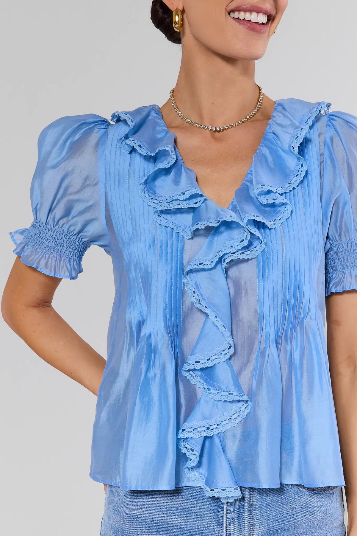 Light blue ruffle blouse with lace-trim ruffles and micro-pleating - Close-Up Detail | Avara