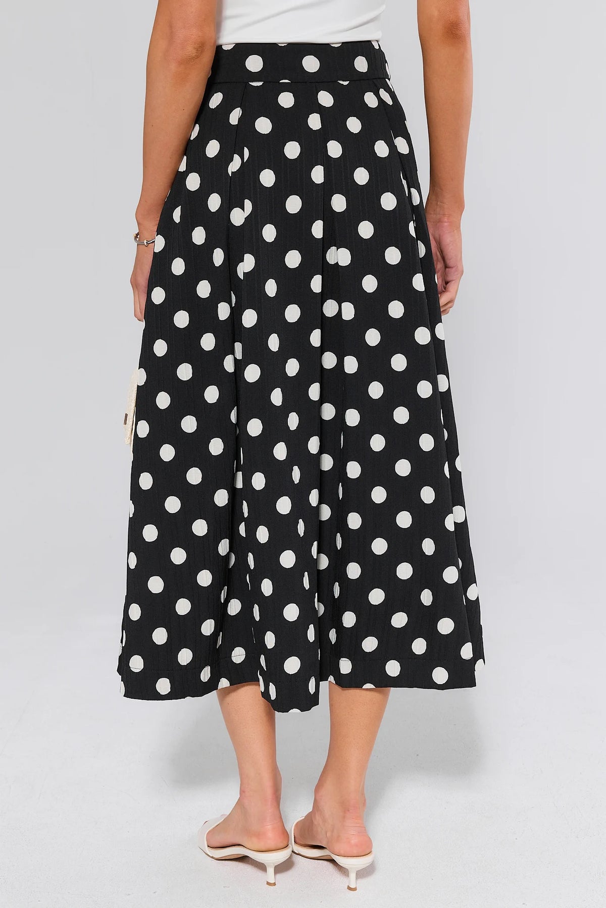 Collins Black Polka Dot Midi Skirt - Back View with Pleated A-Line Silhouette | Avara