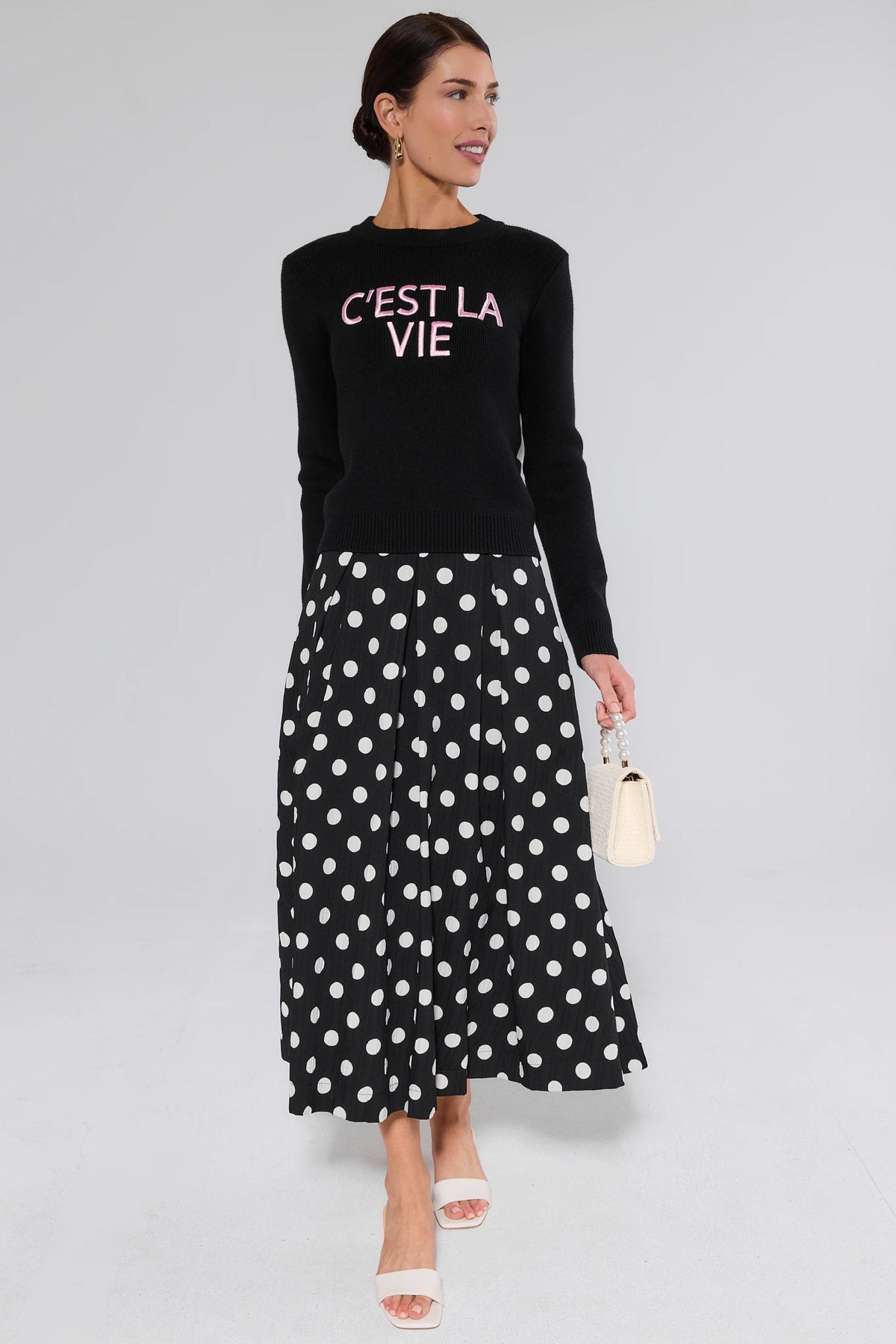 Collins Black Polka Dot Midi Skirt Styled with Black Sweater and Pearl Bag - Full Look | Avara