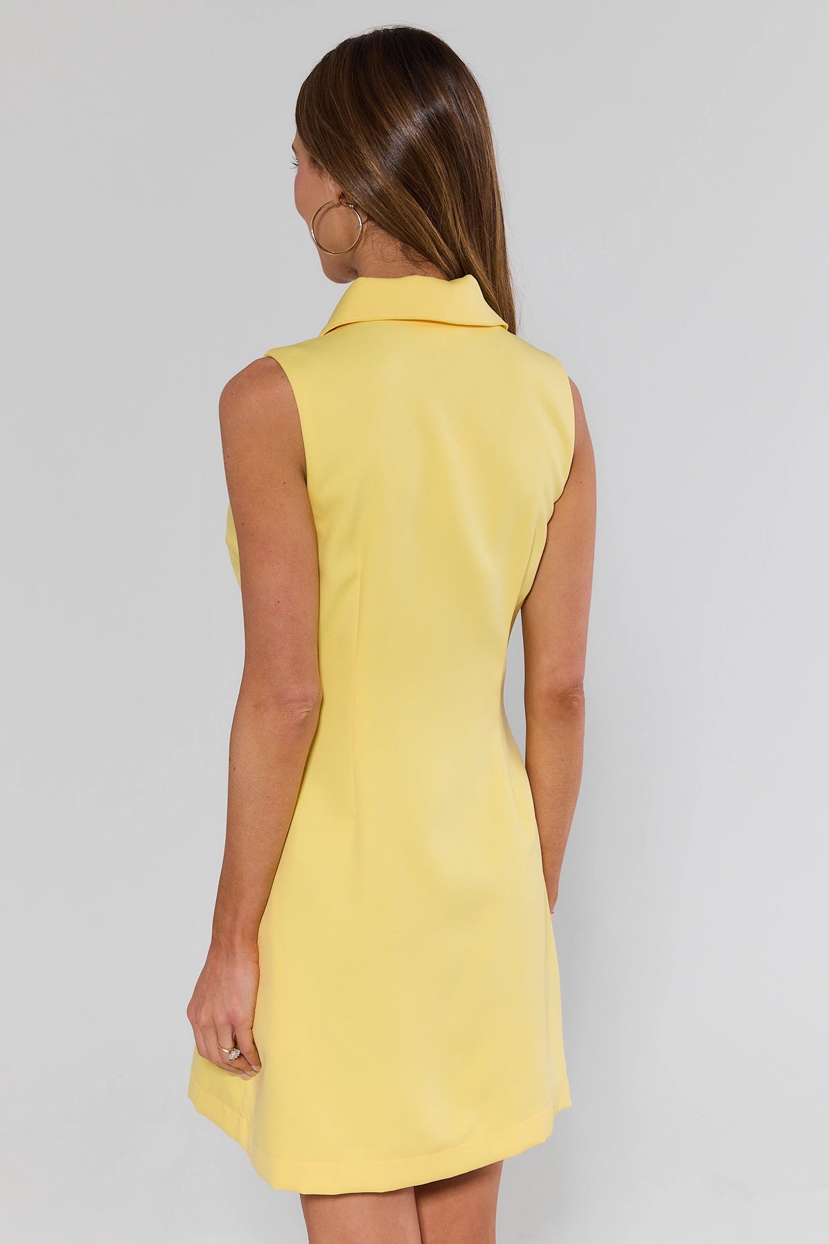 Yellow button-front sleeveless short dress showing clean back silhouette - Back View | Avara