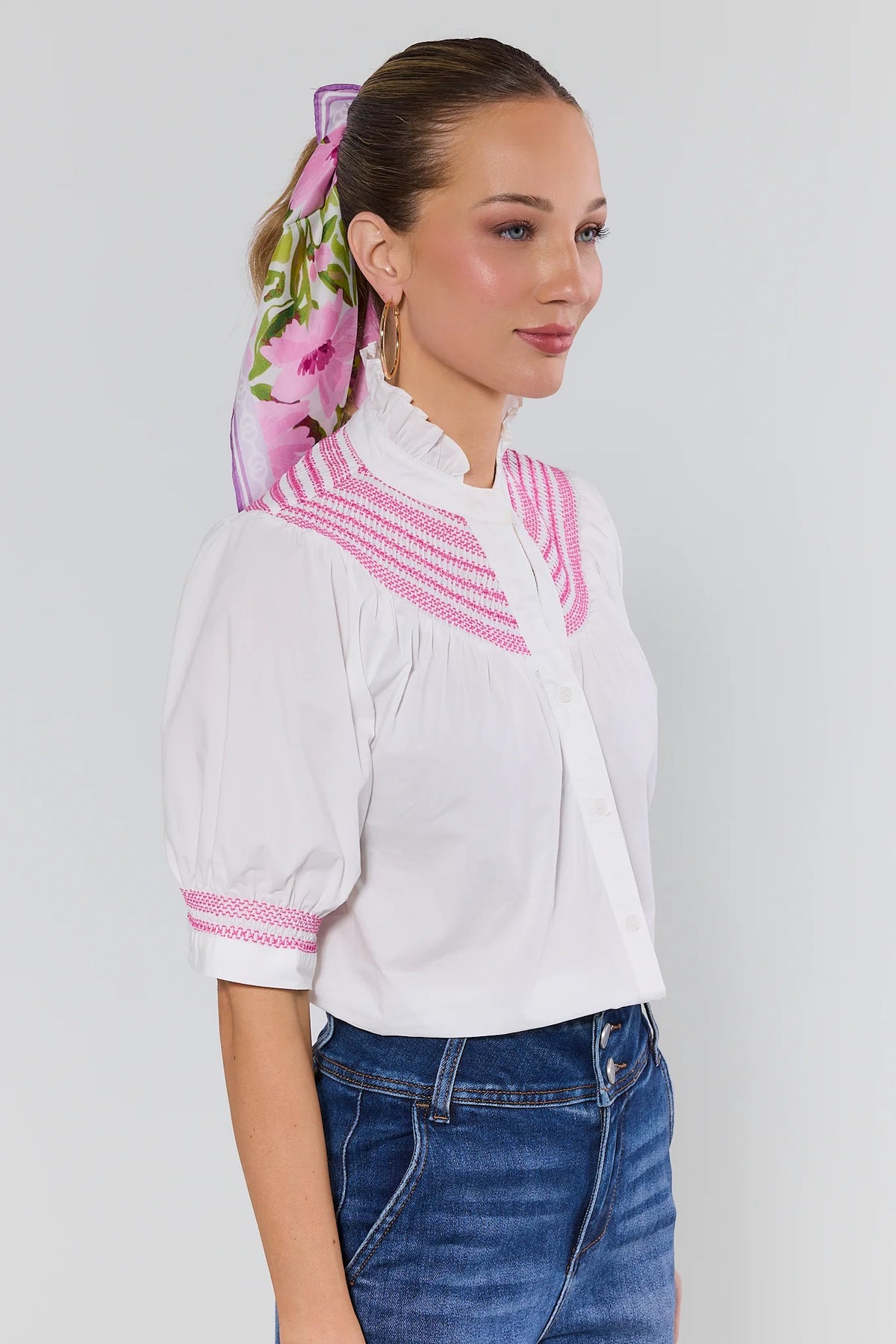 Yvonne White Pink Embroidered Top showing puff sleeves and pink-trimmed cuffs, styled with jeans - Side View | Avara