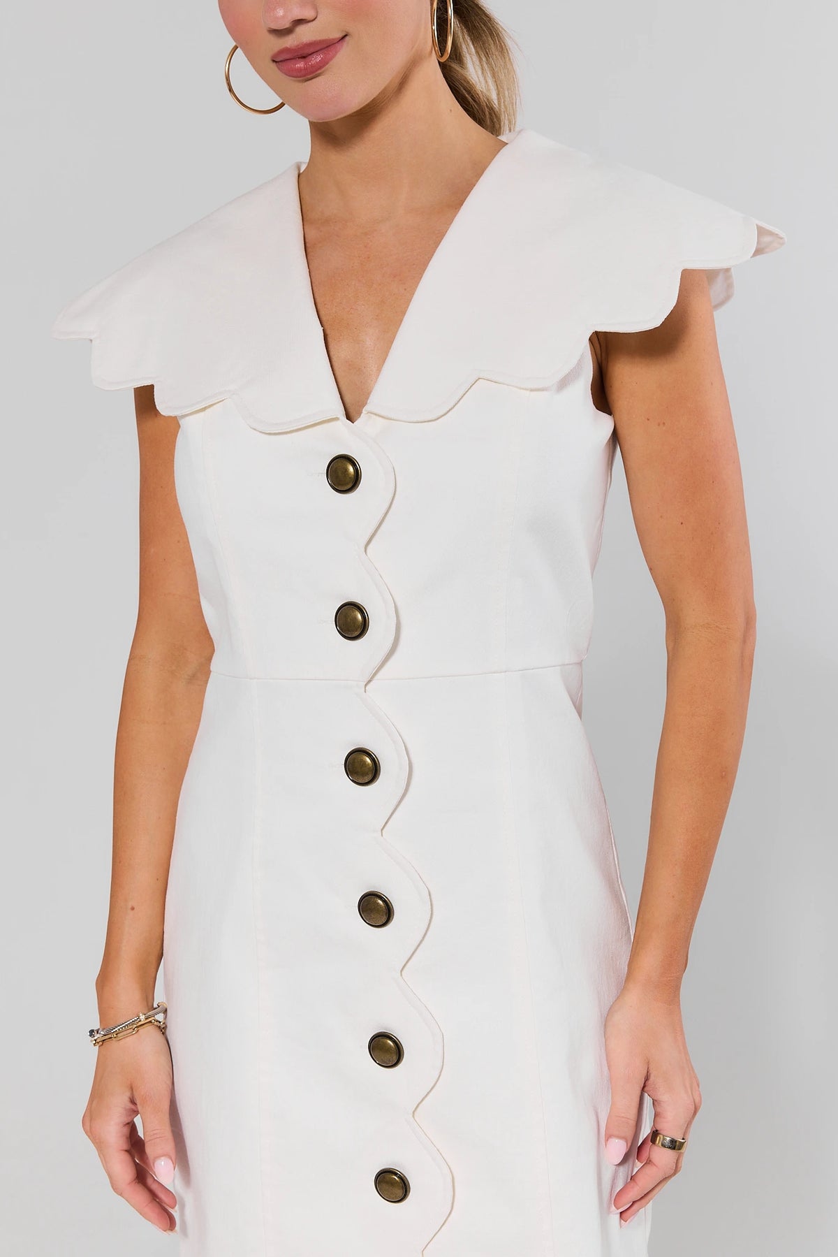 Close-up of white scalloped collar and brass button-front detail on Kaia Short Dress | Avara