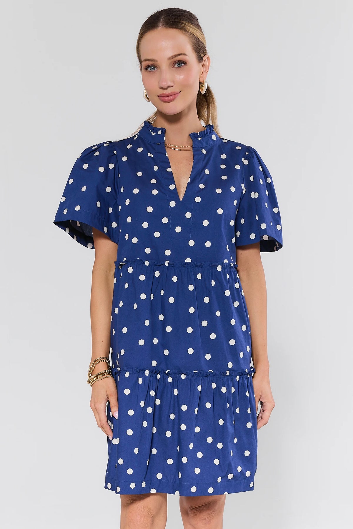 Evan Navy Polka Dot Short Dress - ruffle collar, puff sleeves, tiered skirt, front view on model | Avara