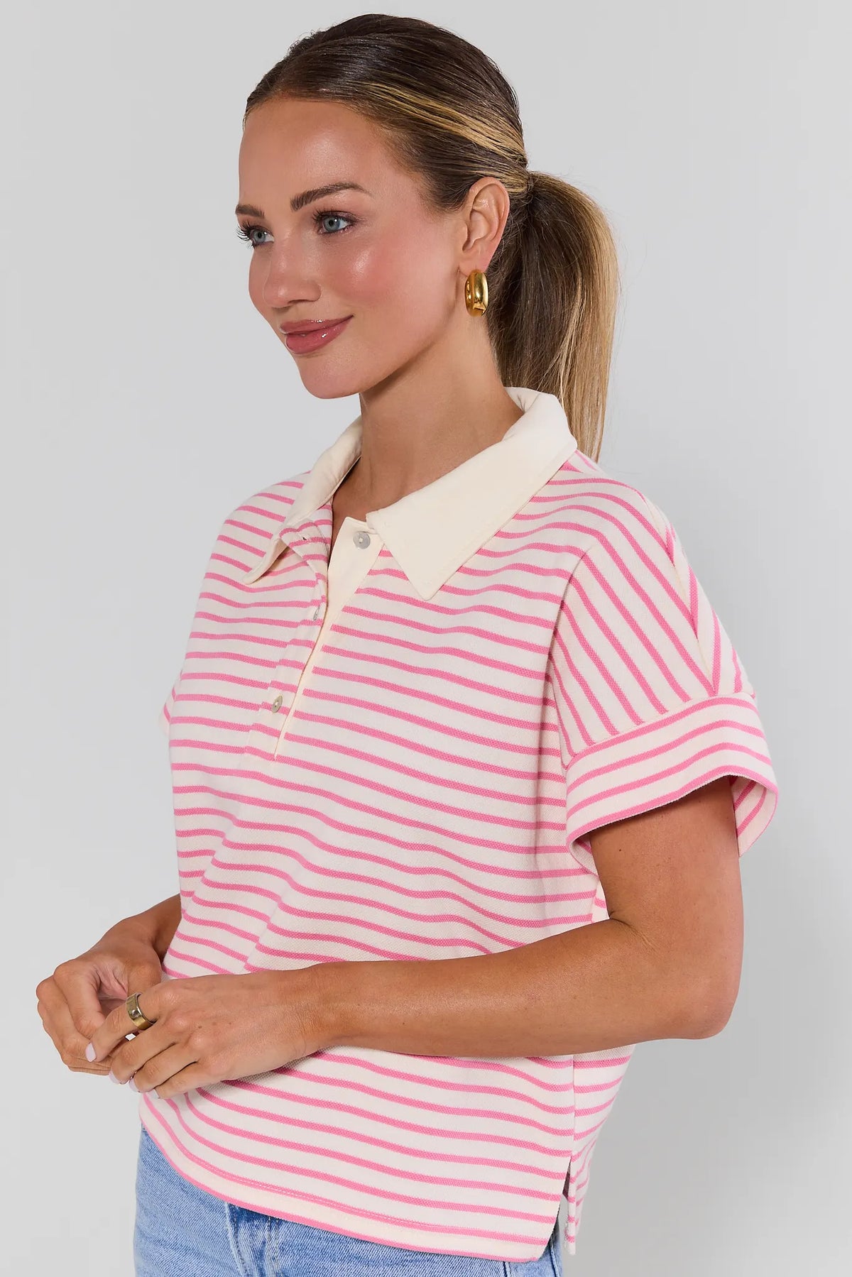 Maeve Pink Striped Collared Top with cuffed short sleeves, angled side view on model | Avara
