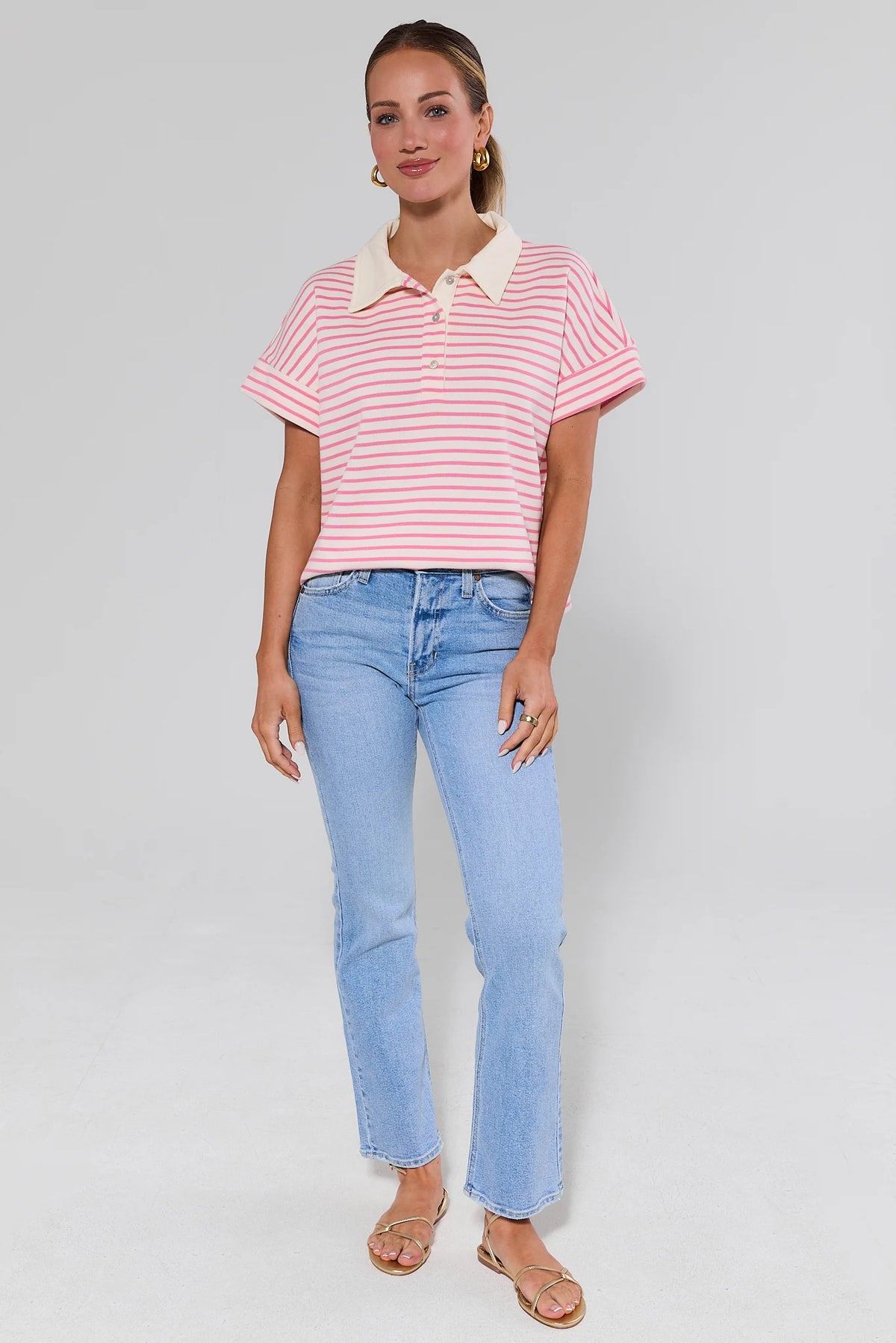 Maeve Pink and White Striped Polo Top styled with light blue jeans, full-length front view | Avara
