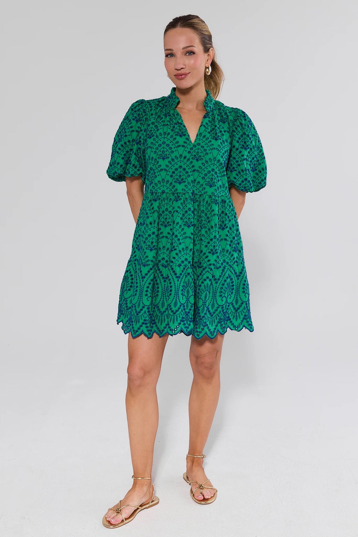 Woman wearing a green lace dress on a white background