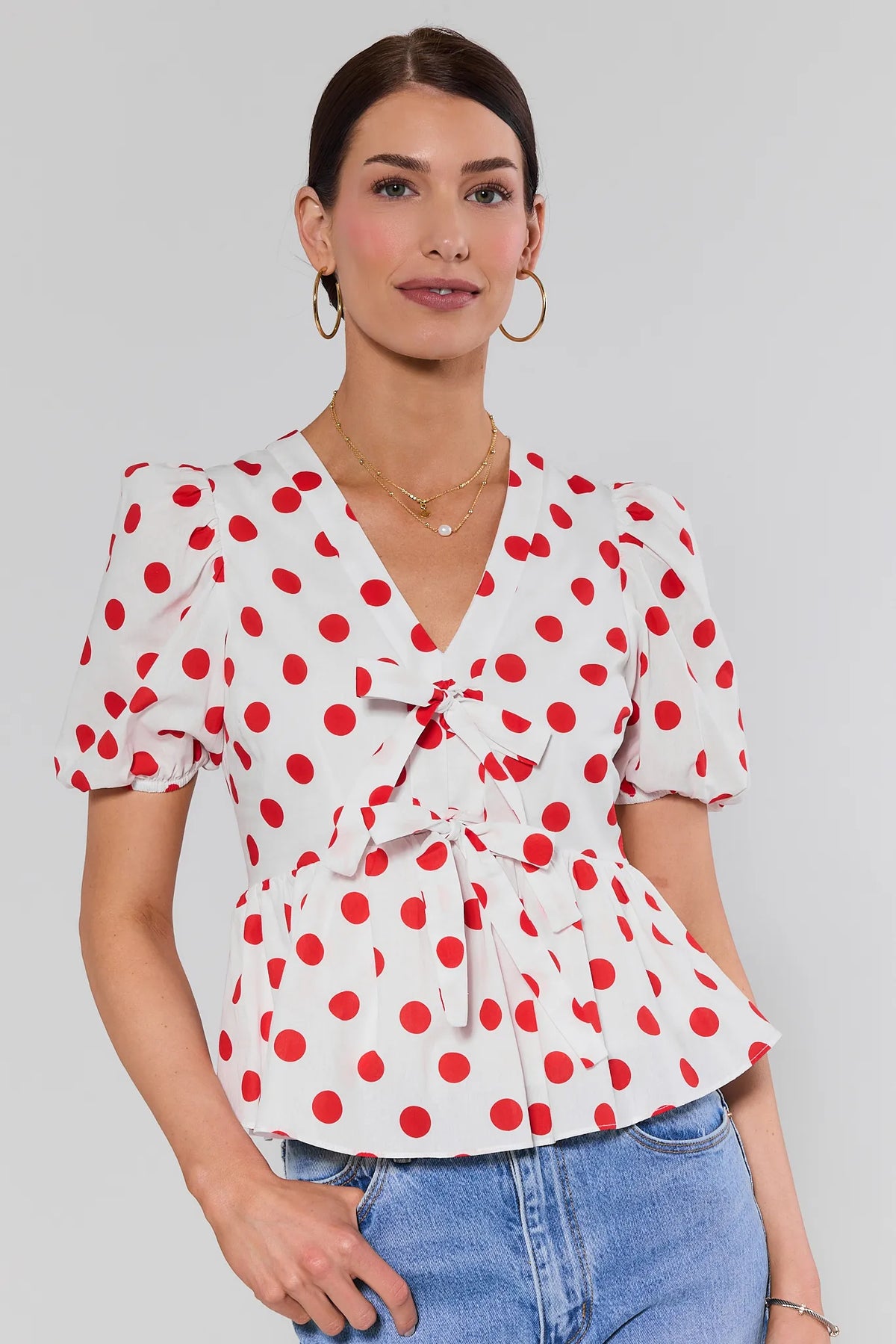 Georgie Red Polka Dot Peplum Top with bow tie front and puff sleeves - Front View | Avara