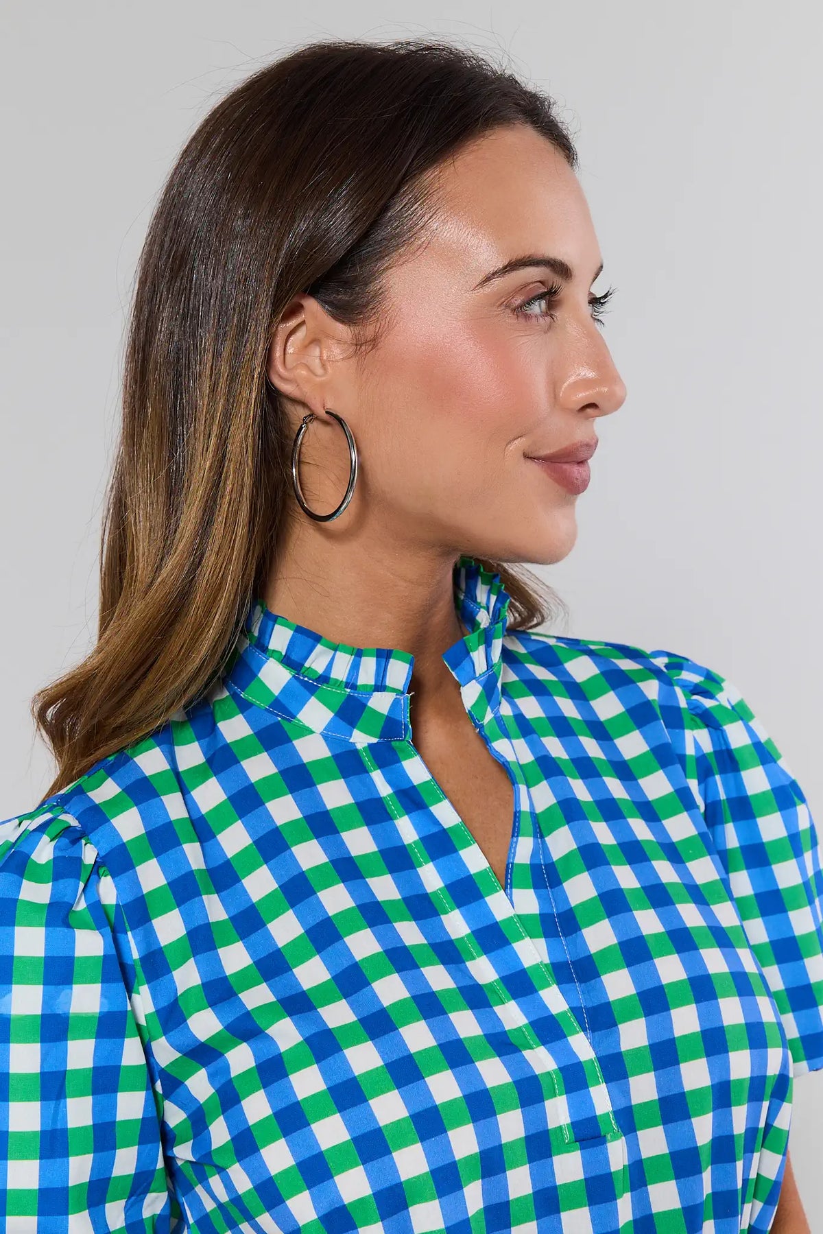Woman wearing Lindsey Silver Small Hoop Earrings styled with blue green gingham top - Side Profile | Avara