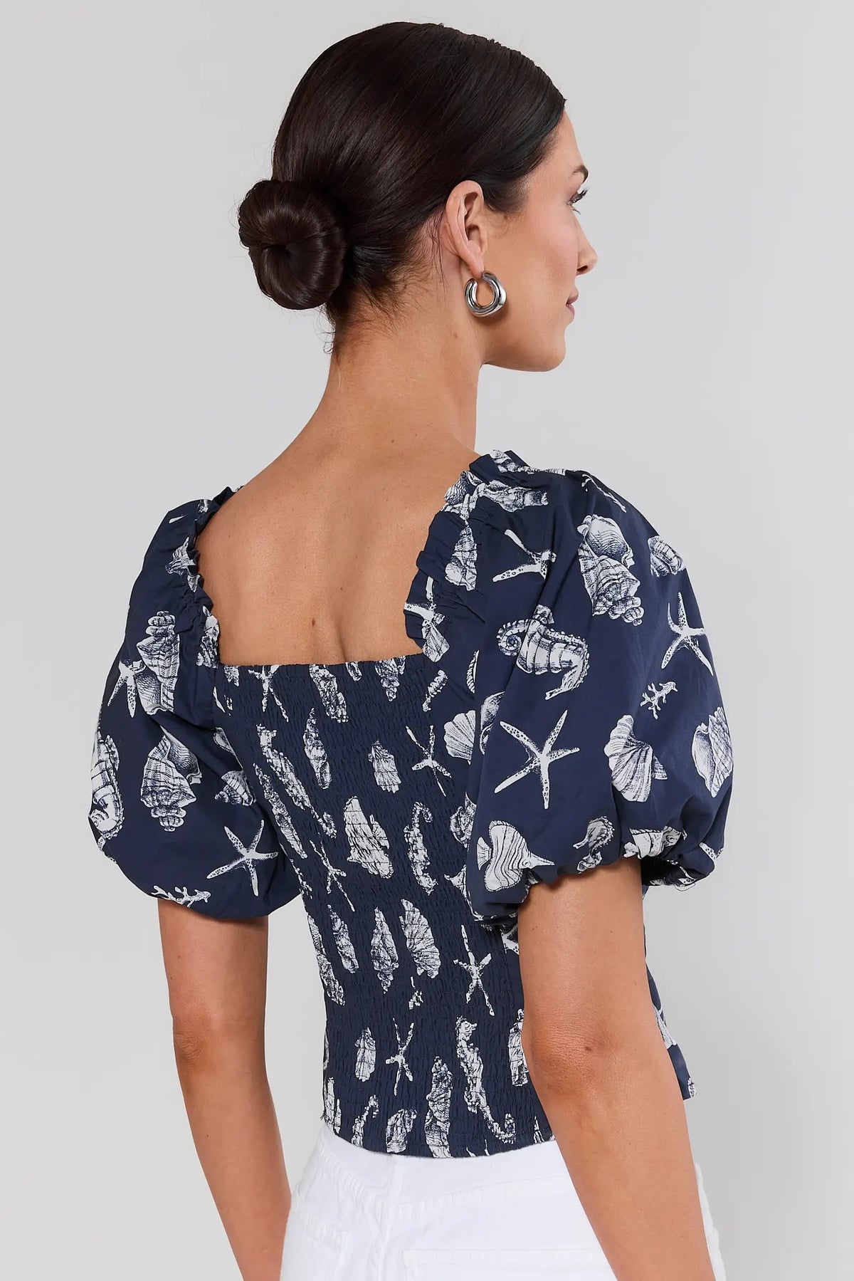Navy seashell print top showing smocked back and puff sleeves - Back View | Avara