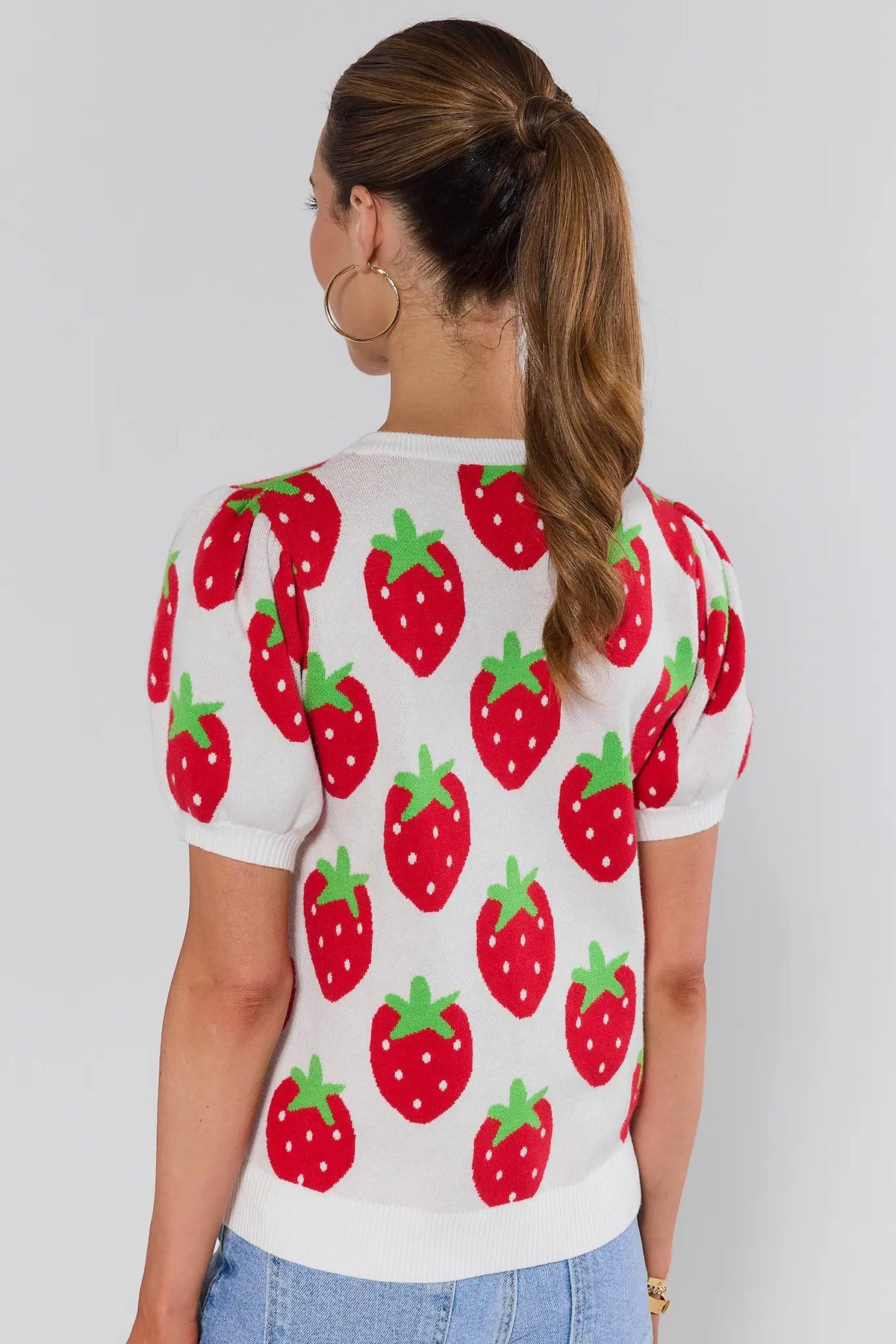 Woman wearing white strawberry short sleeve sweater with allover red intarsia print - Back View | Avara