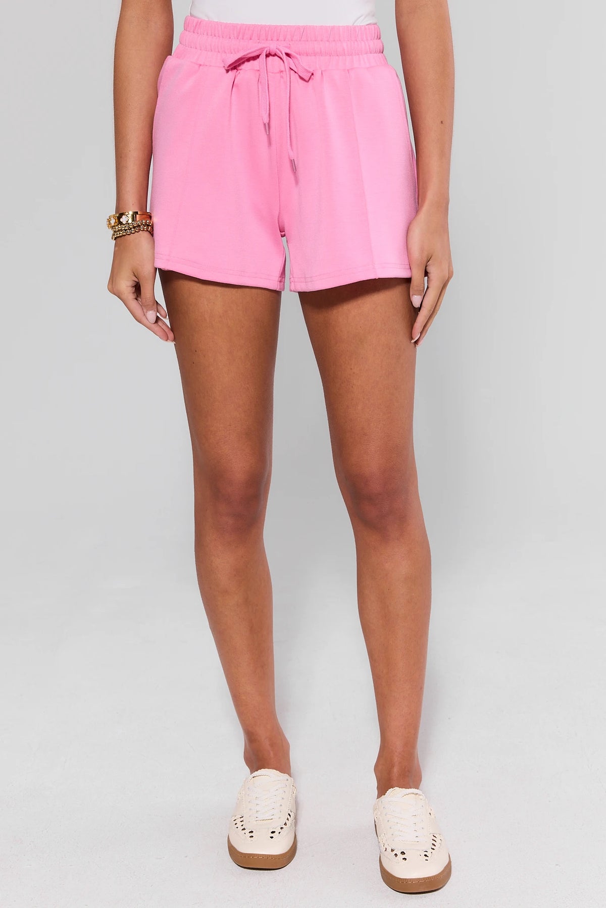 Pink Lexi Sweat Shorts with elastic waist, full-length on model with sneakers - Front View | Avara