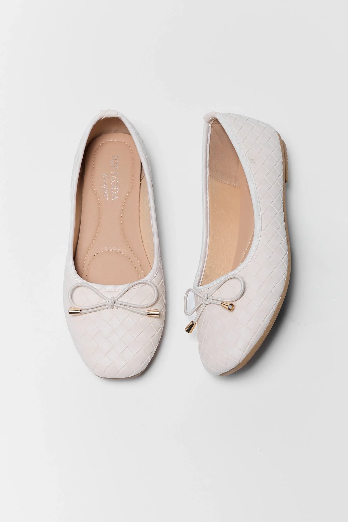 Pair of white woven ballet flats with gold-tipped bow detail - Top View | Avara