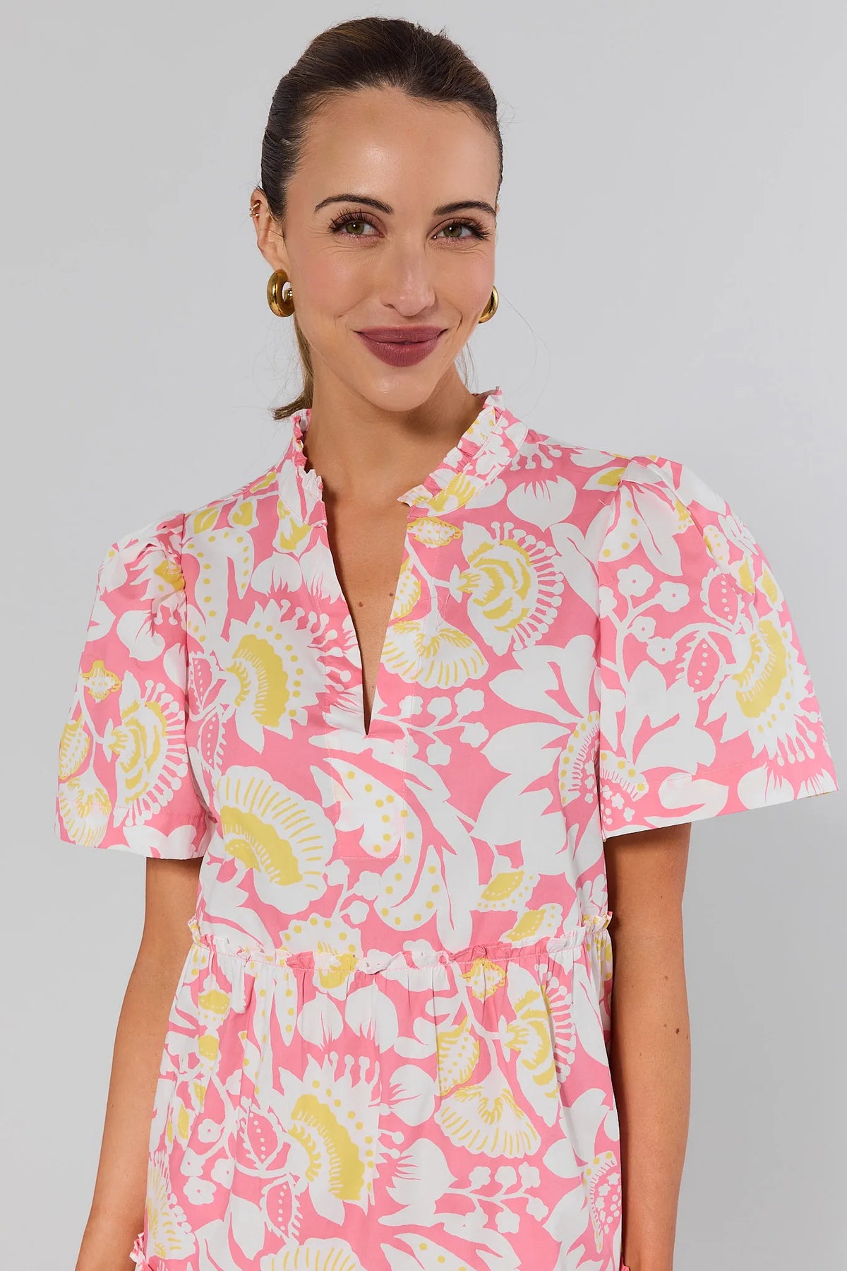 Evan Pink Floral Short Dress close-up showing ruffle neckline and flutter sleeves - Detail View | Avara