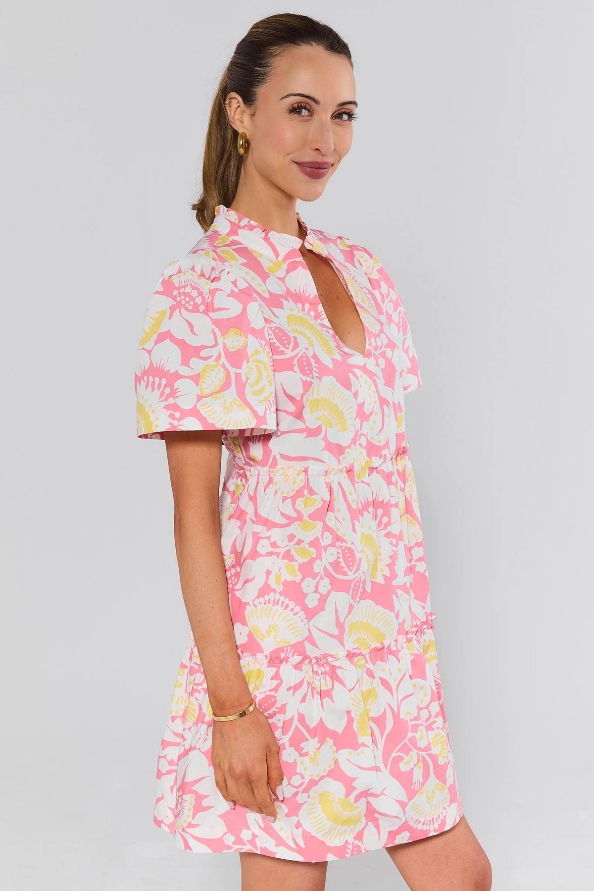 Evan Pink Floral Short Dress side profile view showing puff sleeves and tiered skirt | Avara