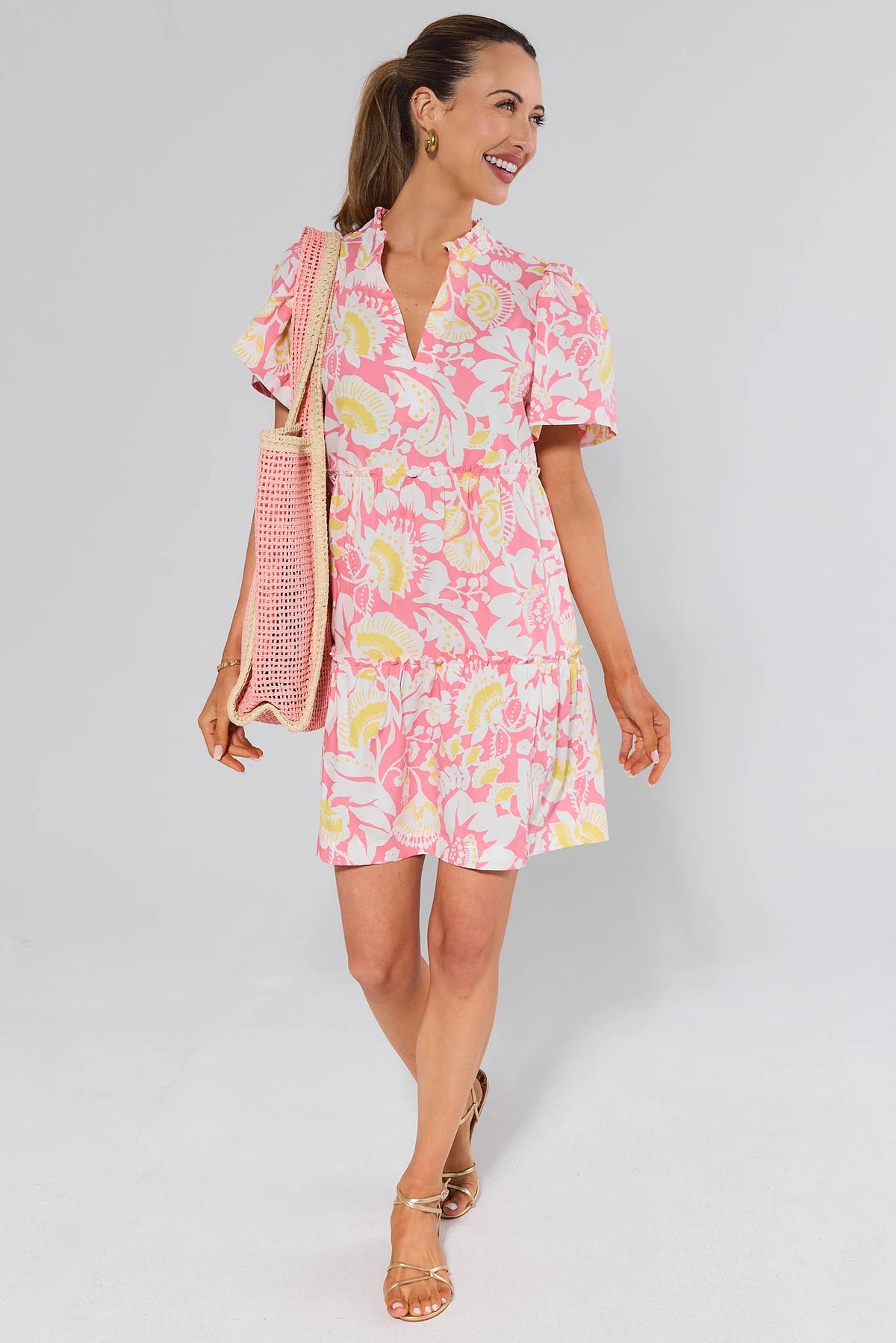 Evan Pink Floral Short Dress angled front view showing tiered hem and short flutter sleeves | Avara