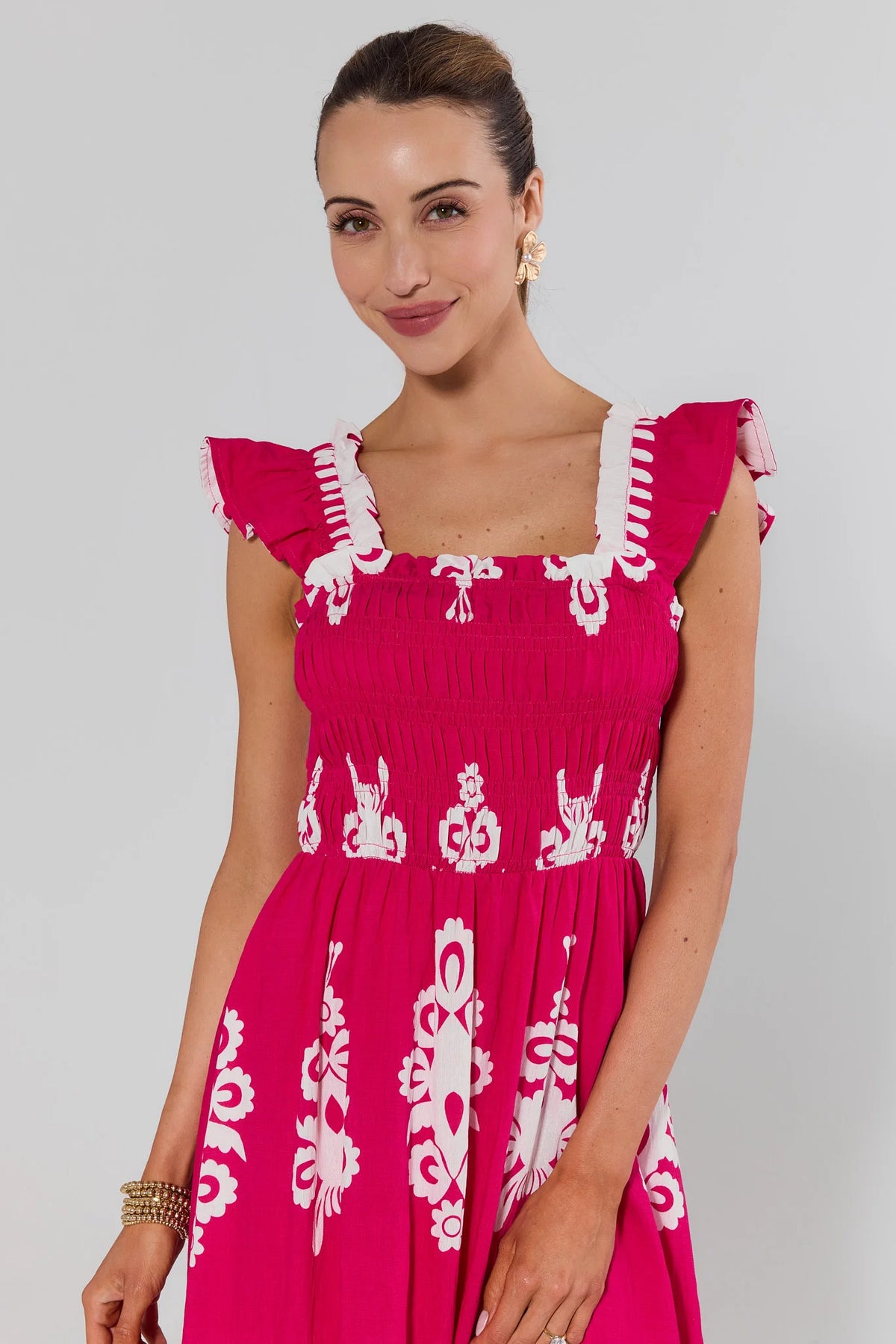 Close-up of hot pink print midi dress smocked bodice and flutter sleeve detail | Avara