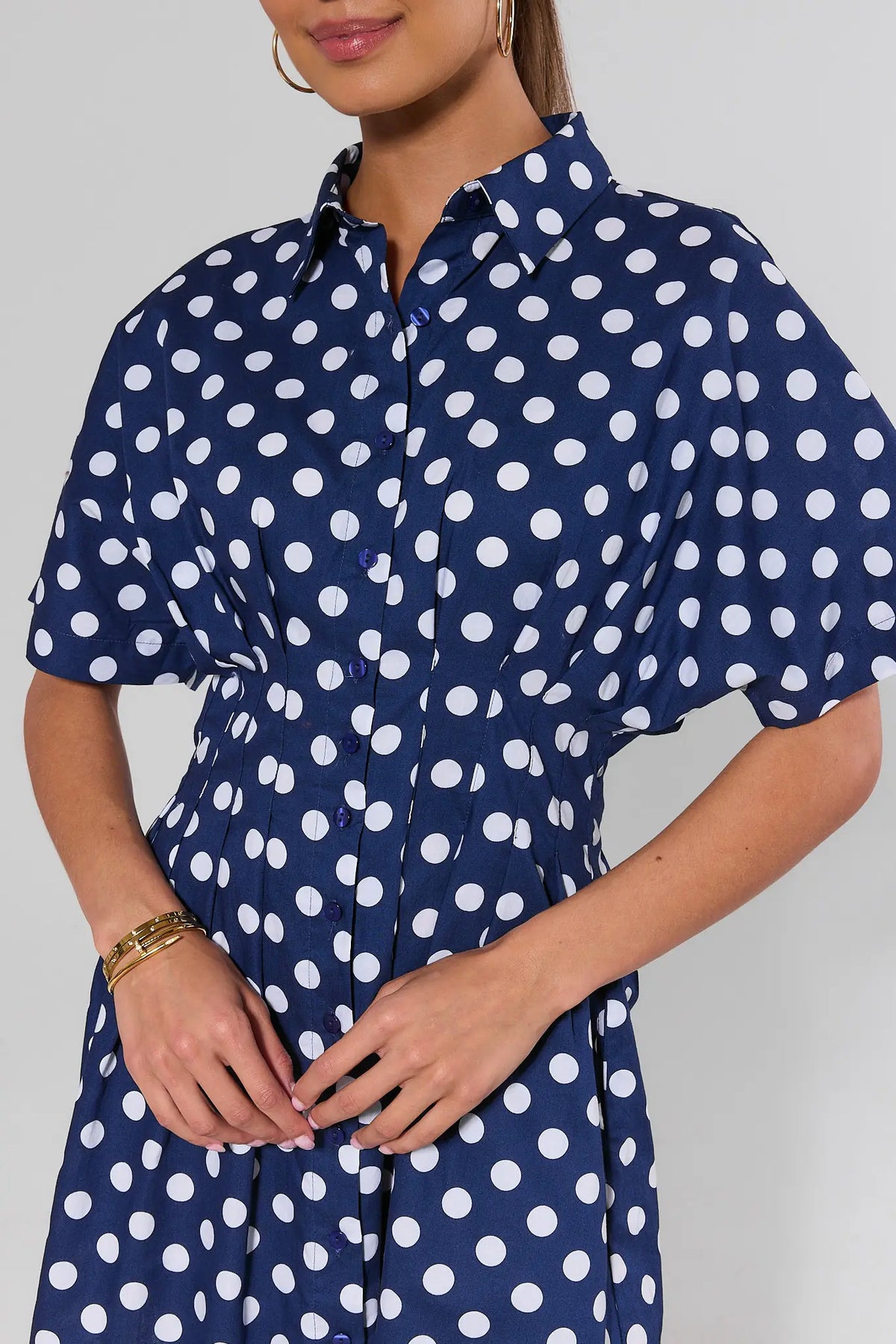 Addison Navy Polka Dot Short Dress close-up showing button placket, collar, and fitted waist detail | Avara