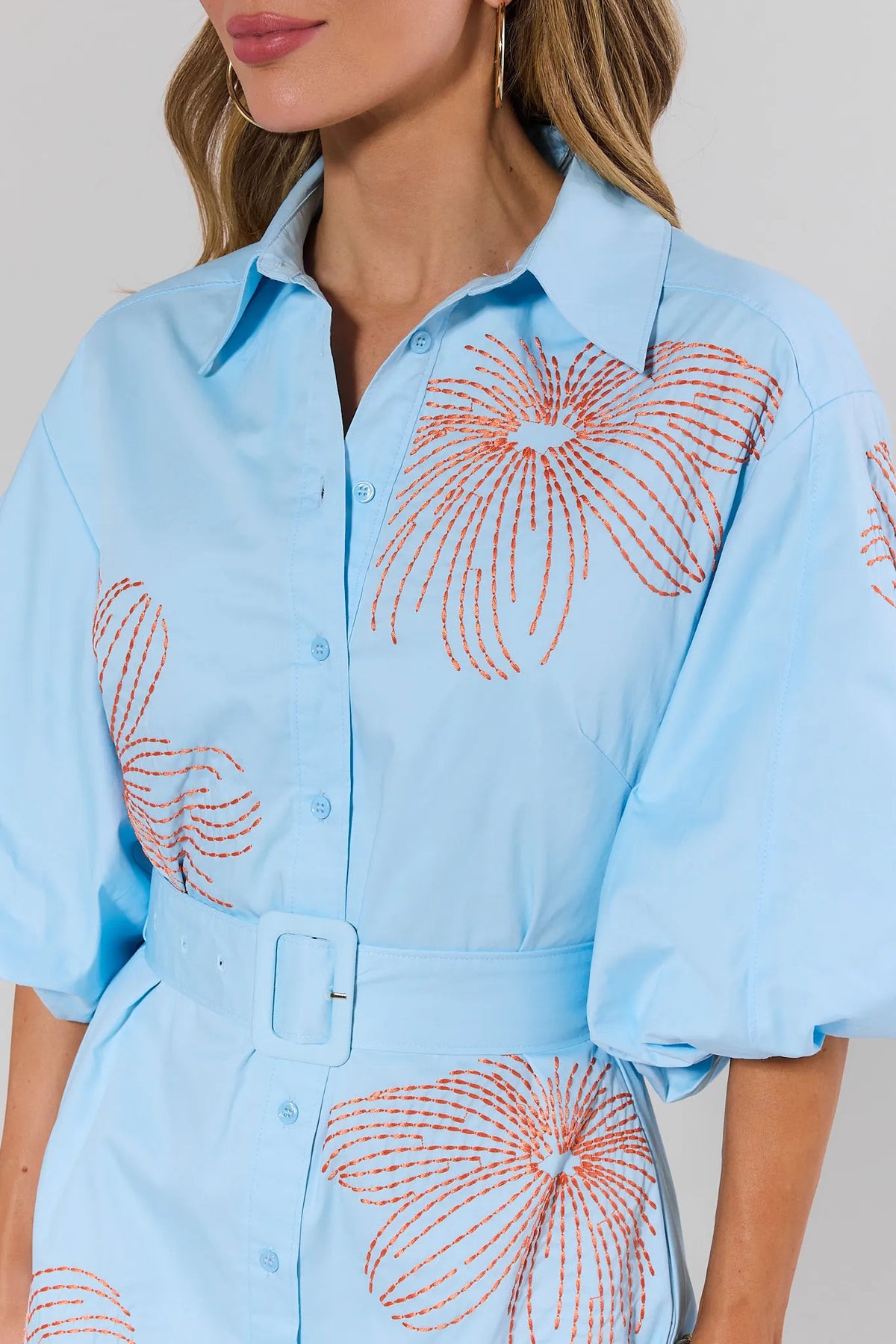 Regina Blue Embroidered Short Dress - Close-Up of orange floral embroidery and belt detail | Avara