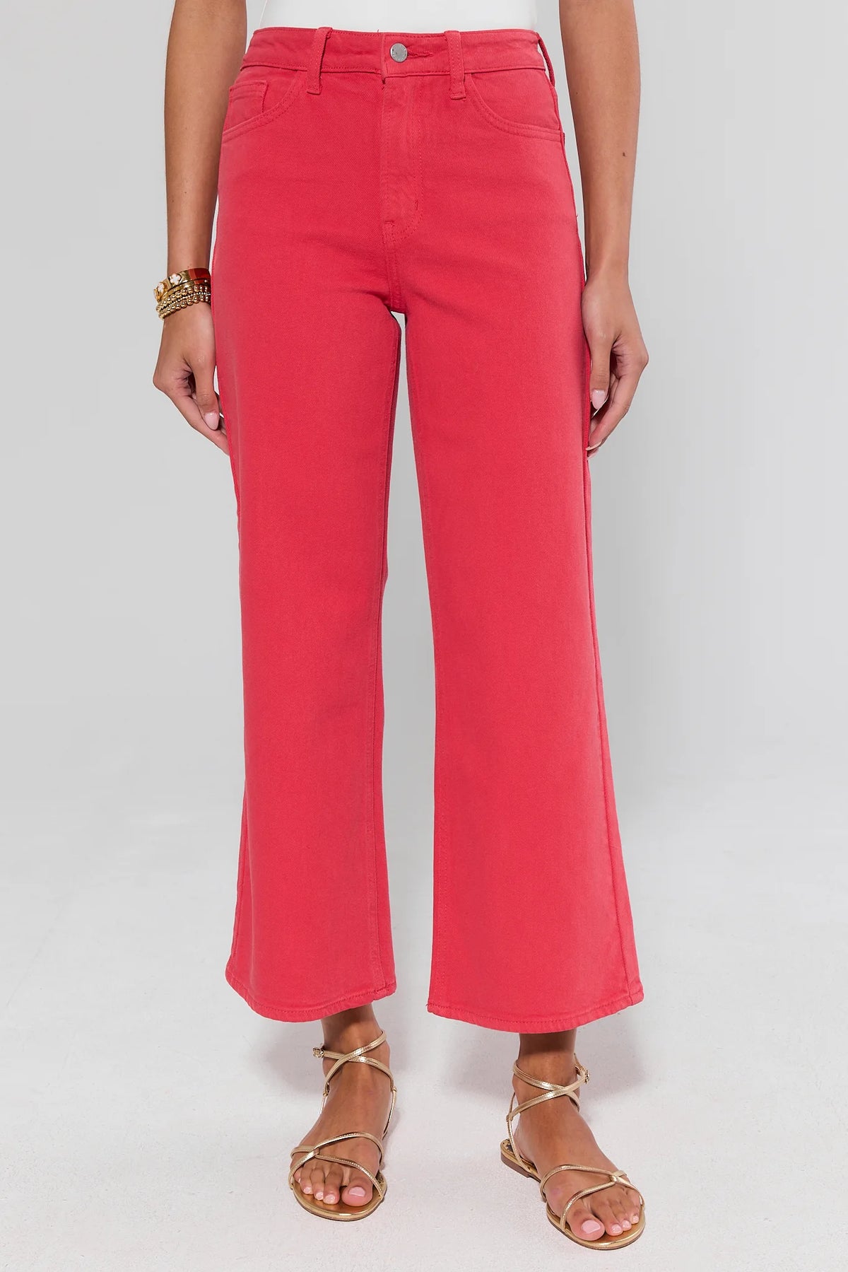 Person wearing bright pink pants on a white background
