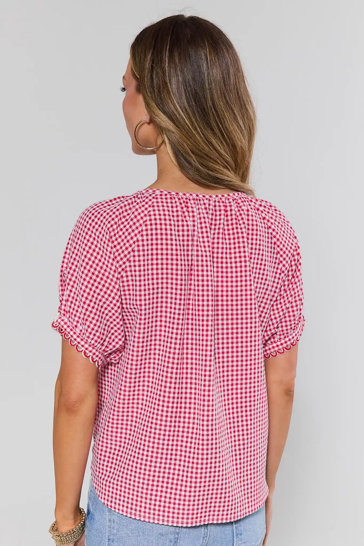Red gingham button-up top showing relaxed back silhouette with scalloped short sleeves and center seam — Back View | Avara
