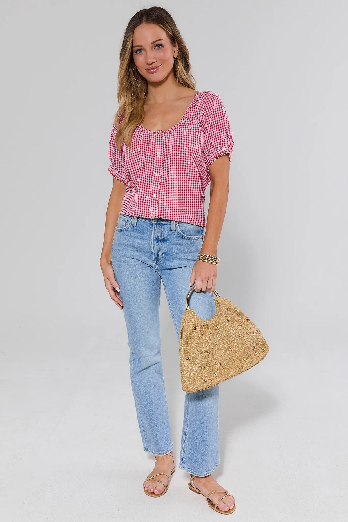 Red gingham top styled with light-wash straight jeans and studded straw bag — Full Length Outfit View | Avara