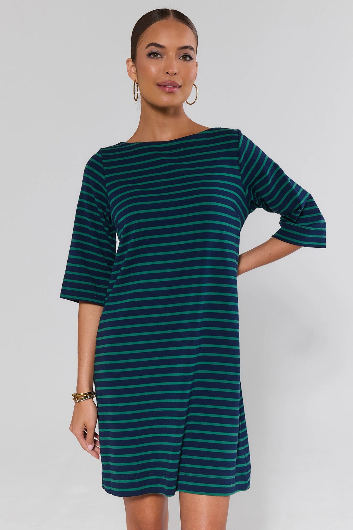 Woman wearing a green and navy striped shirt dress with boat neckline and 3/4 sleeves - Front View | Avara