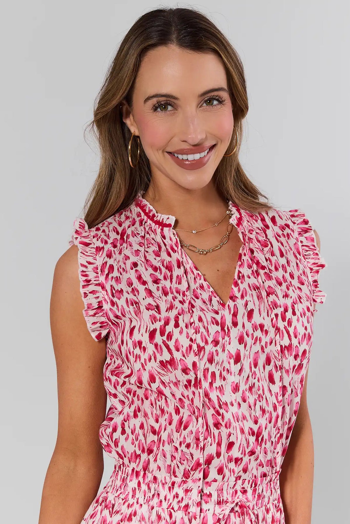 Close-up of pink printed dress ruffle neckline and abstract print detail - Neckline Detail | Avara