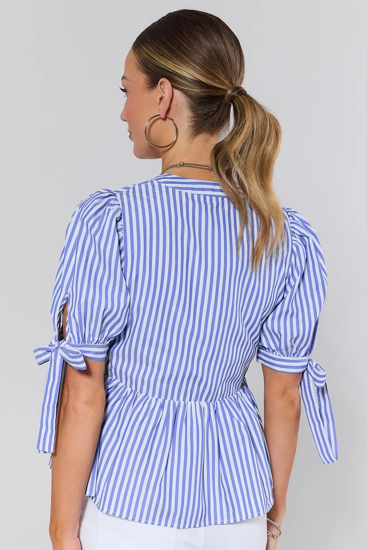 Women's blue and white striped peplum blouse with tie sleeves and peplum hem - Back View | Avara