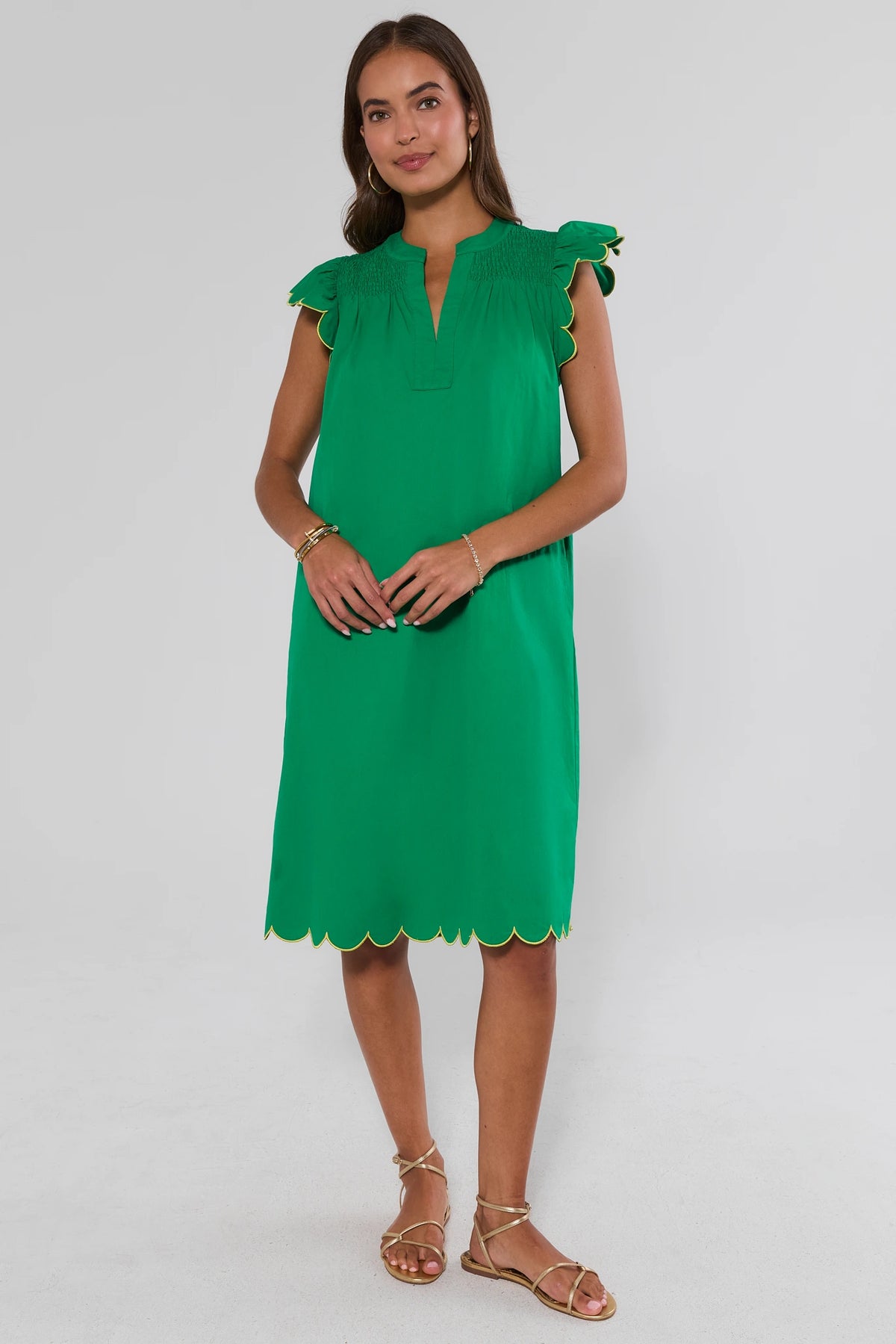 Green flutter sleeve midi dress with scalloped hem styled with gold sandals - Full Length | Avara