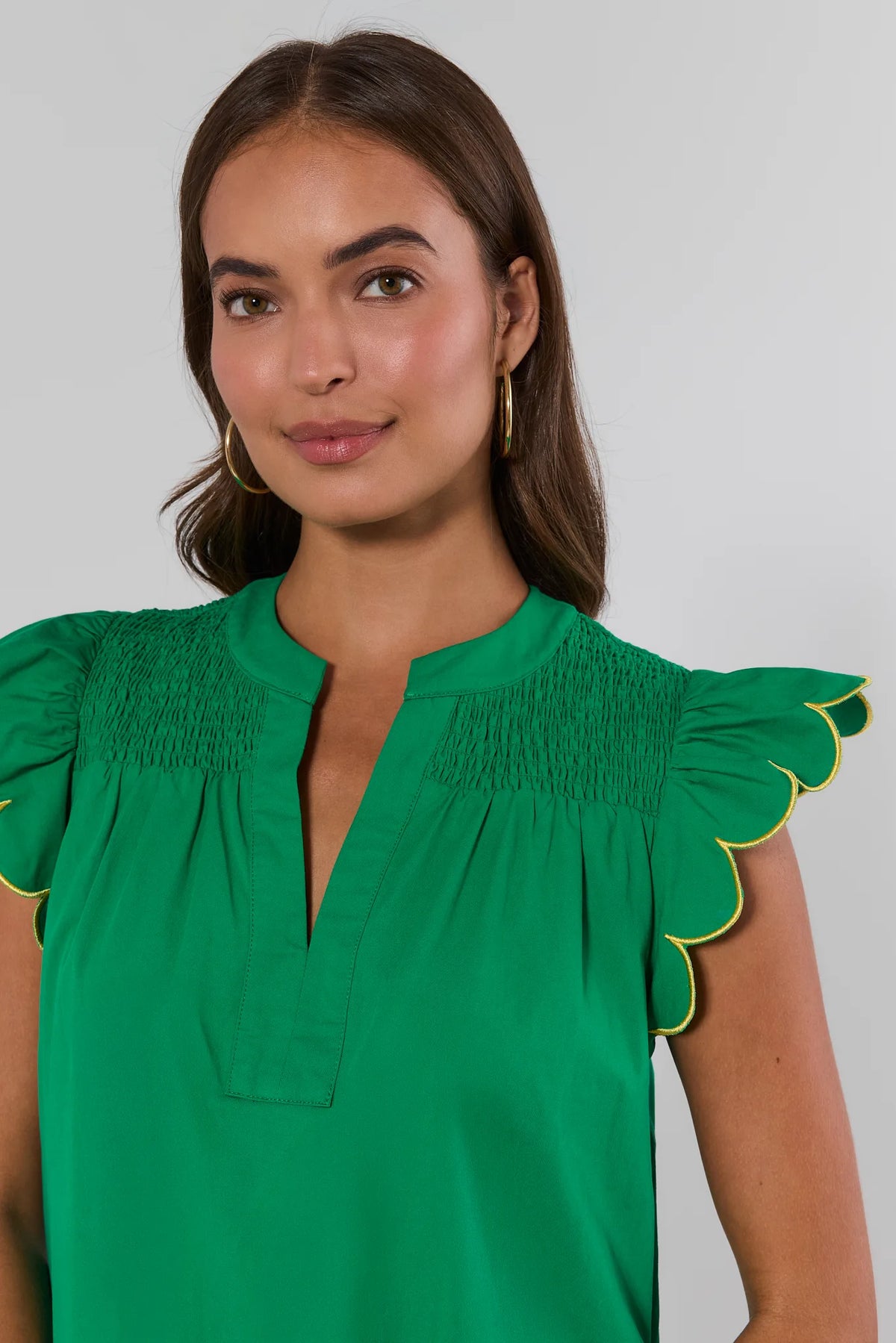 Green scalloped flutter sleeve dress with smocked neckline and yellow trim detail - Close-Up | Avara