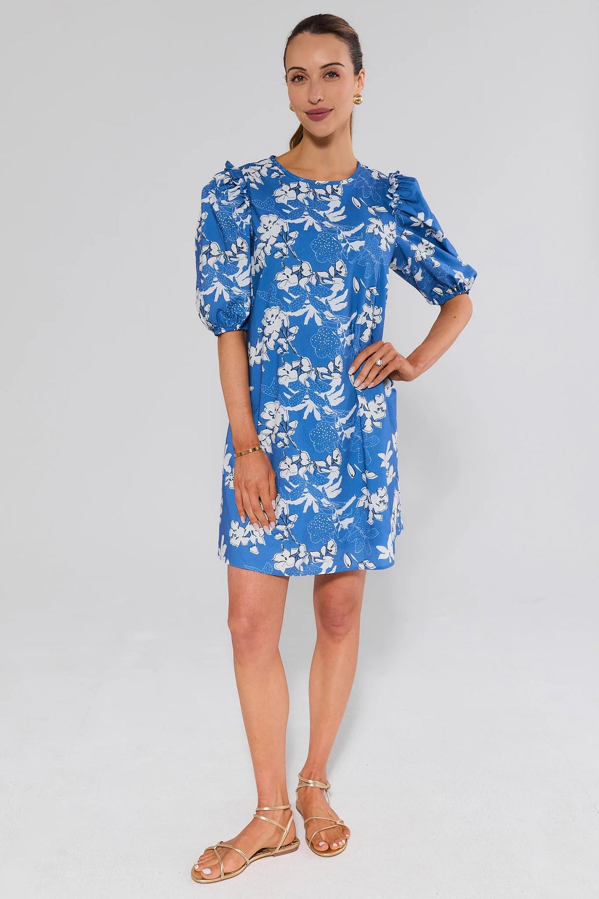 Blue floral puff sleeve short dress with A-line silhouette, styled with gold sandals - Front View | Avara