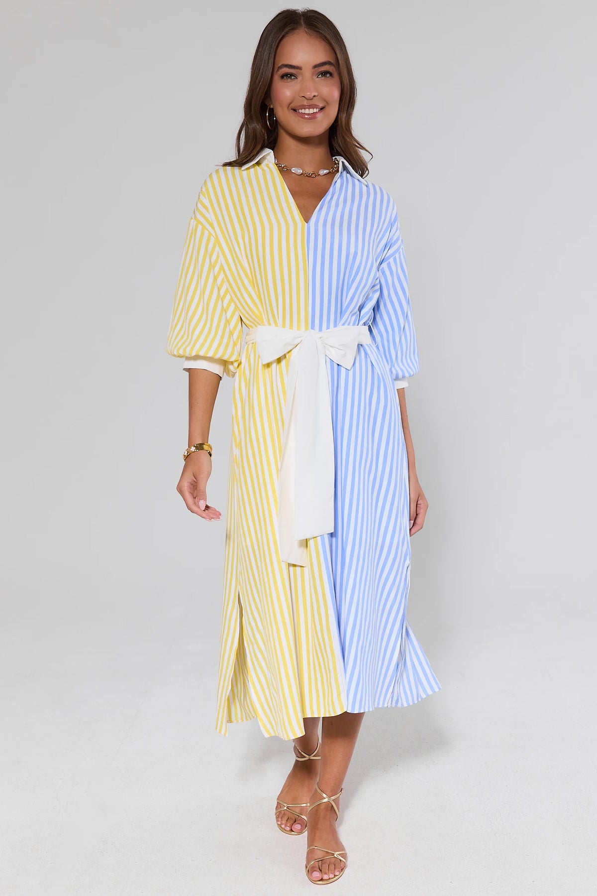 Blue and yellow two-toned striped midi dress with white tie-belt, front view on model | Avara