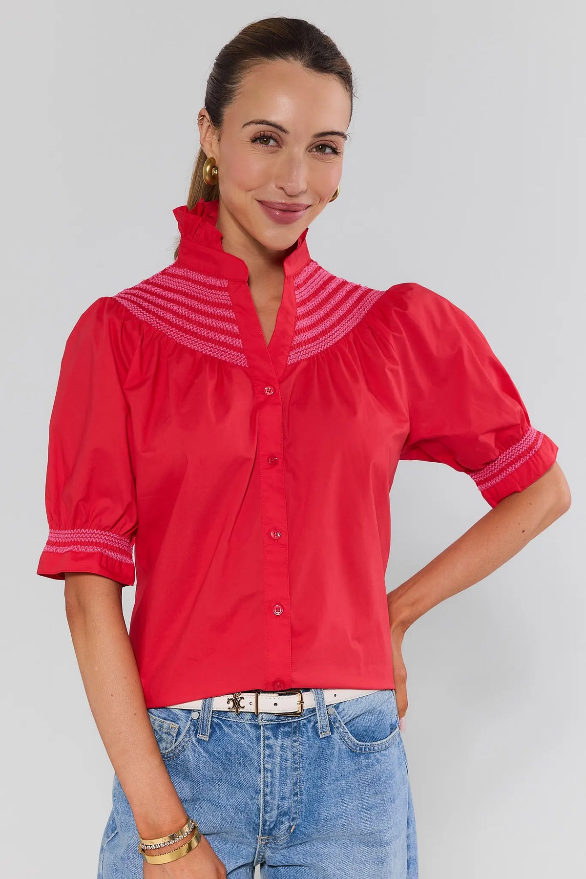 Red embroidered button-up top with ruffle collar and puff sleeves, styled with jeans - Front View | Avara