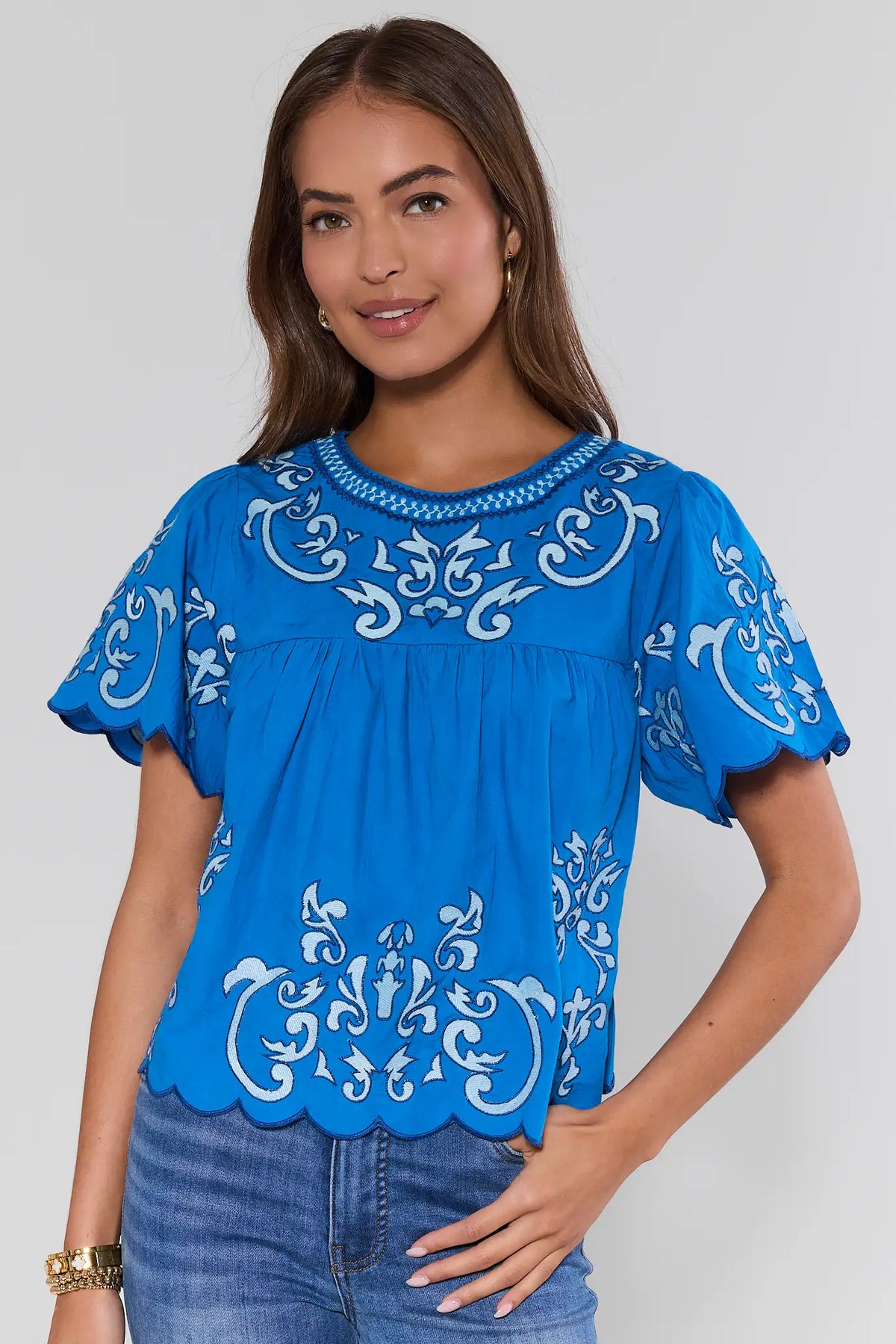 Blue embroidered scalloped hem top with flutter sleeves - Front View, On Model | Avara