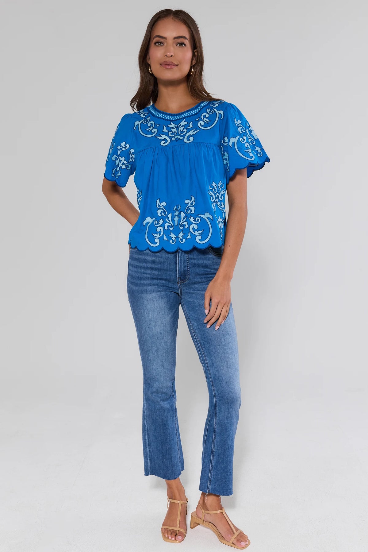 Blue embroidered scalloped hem top styled with jeans and sandals - Full Length Front | Avara