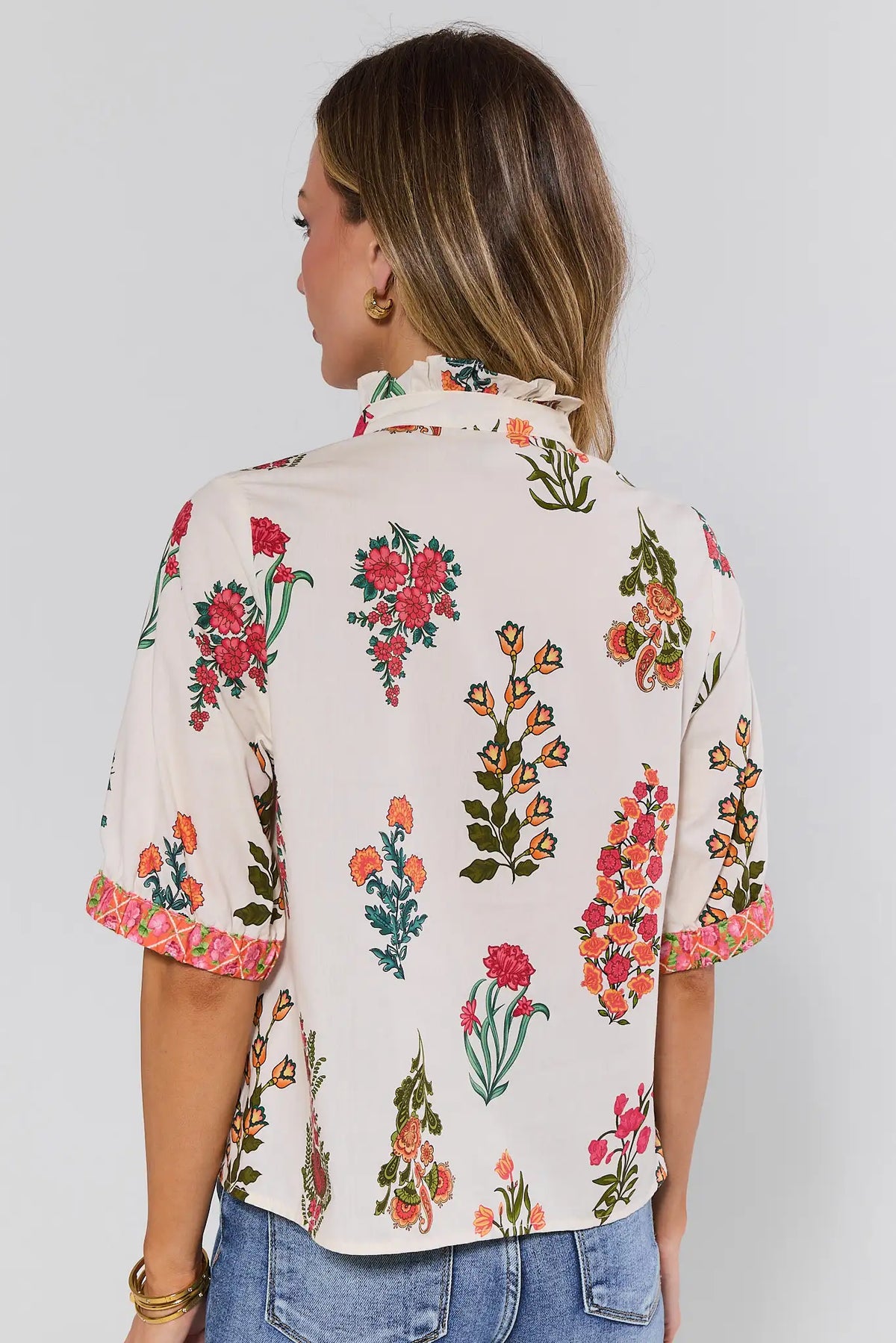 Back view of women's white floral button-up top by THML with elbow sleeves and pink contrast cuffs | Avara